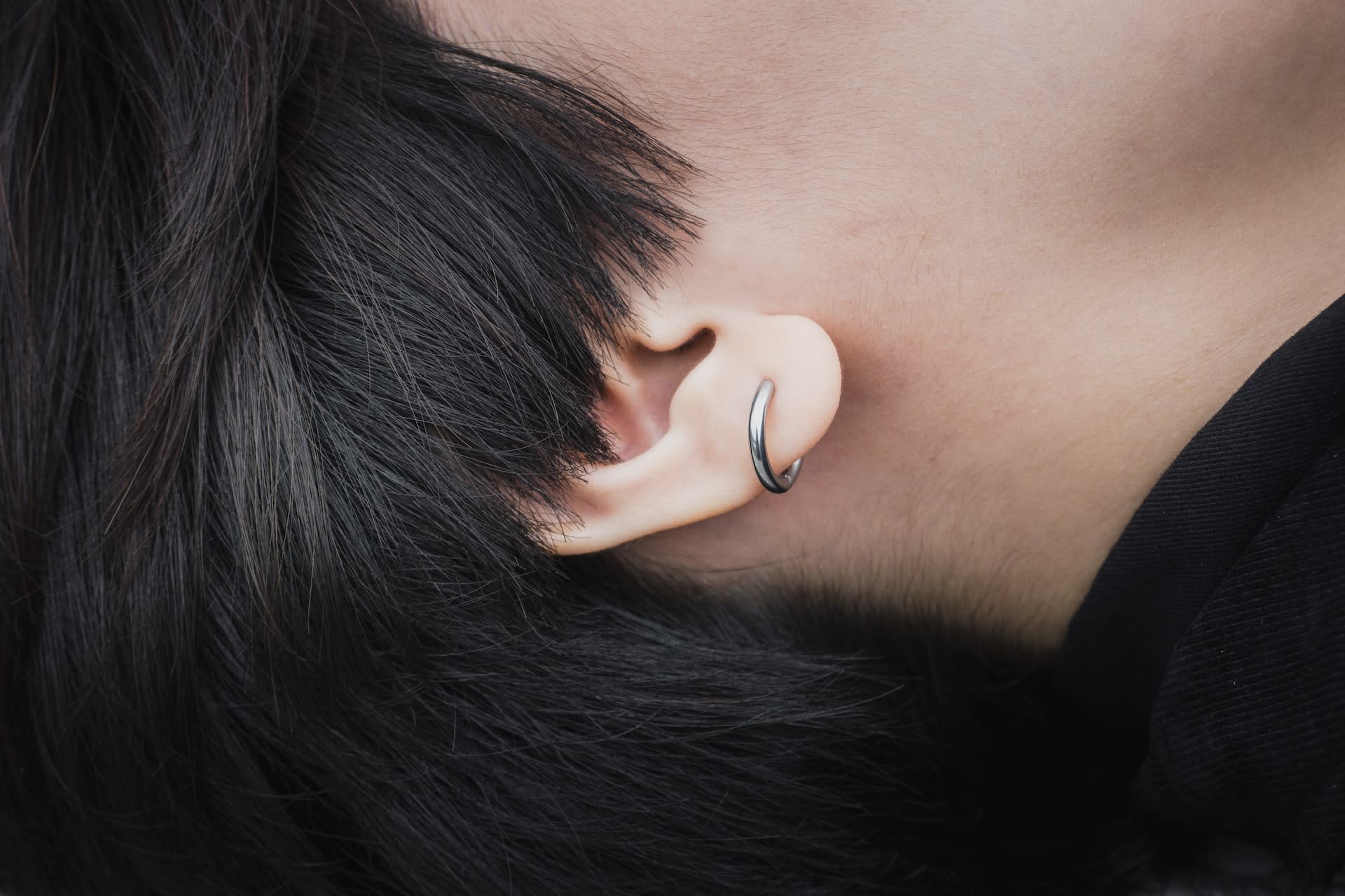 Simple silver hood in mans ear