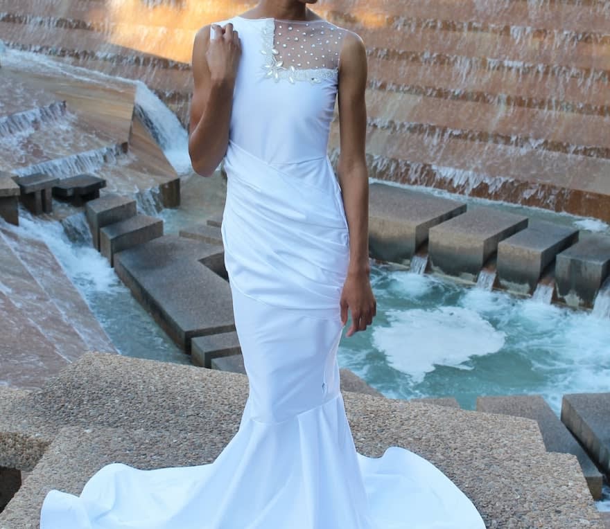 Woman wearing a vintage white fishtail dress