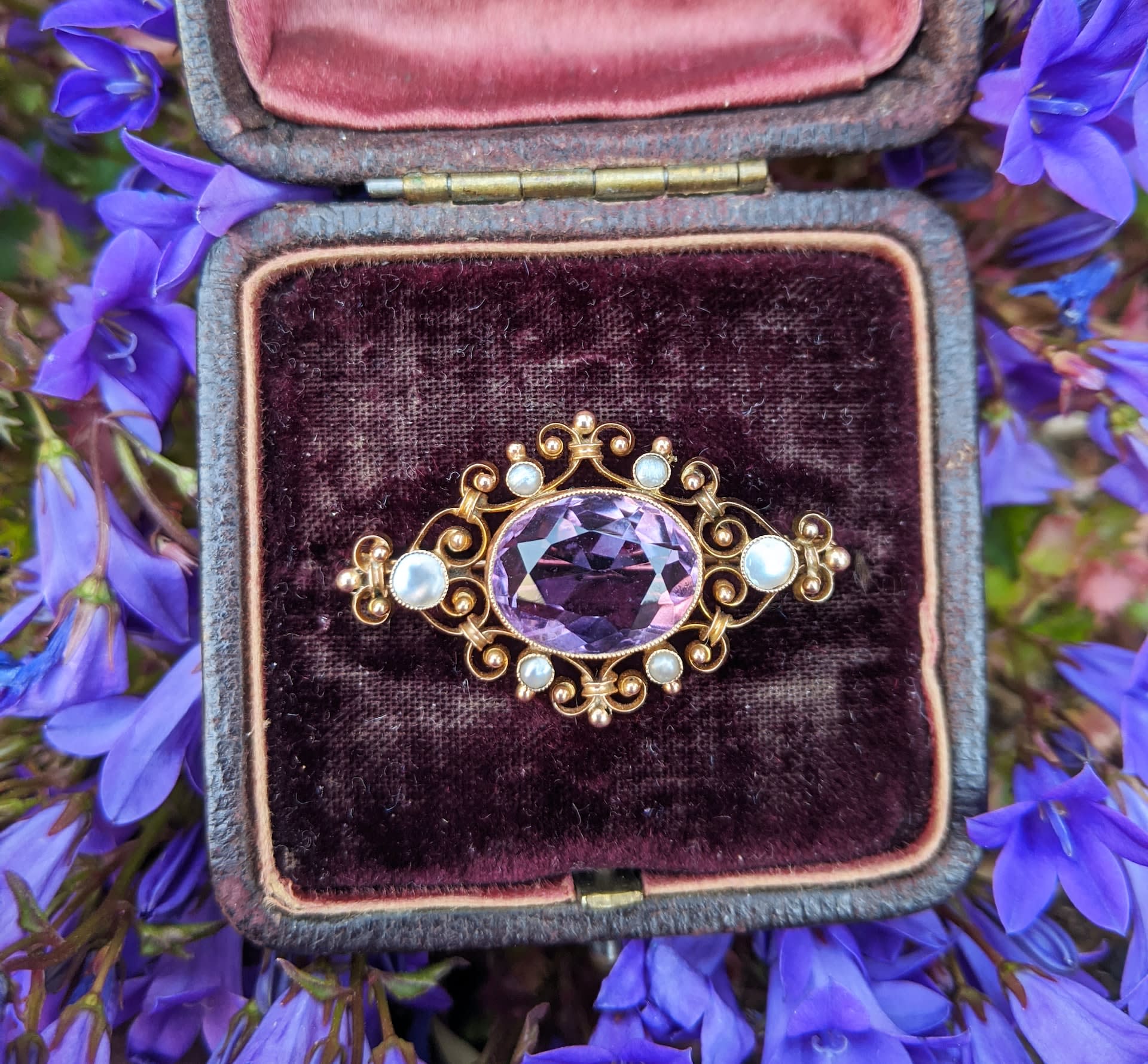 Vintage gold, pearl, and purple crystal brooch in a box