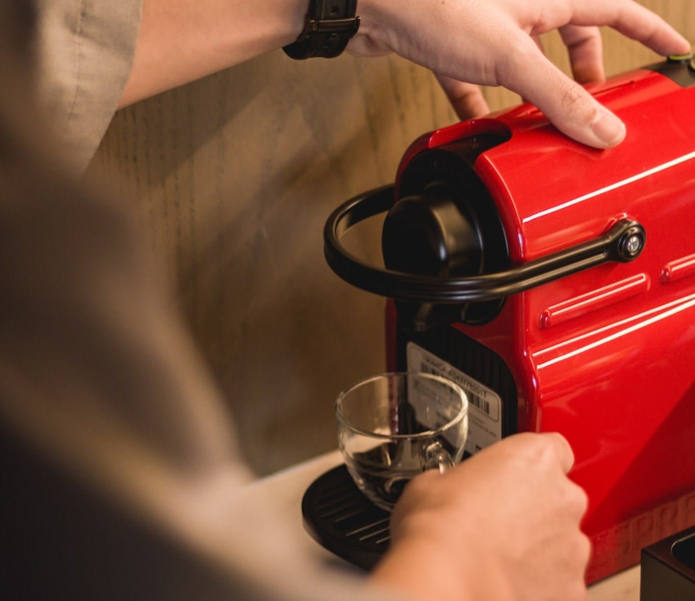 Man using red coffee pod machine