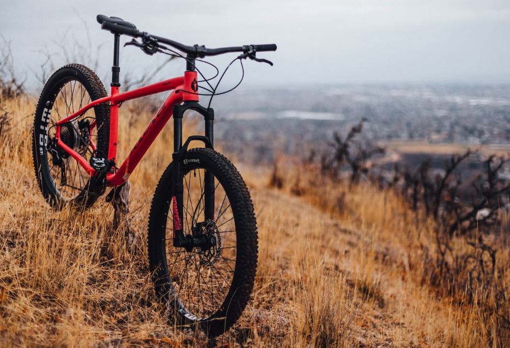 Red mountain bike standing on top of a mountain