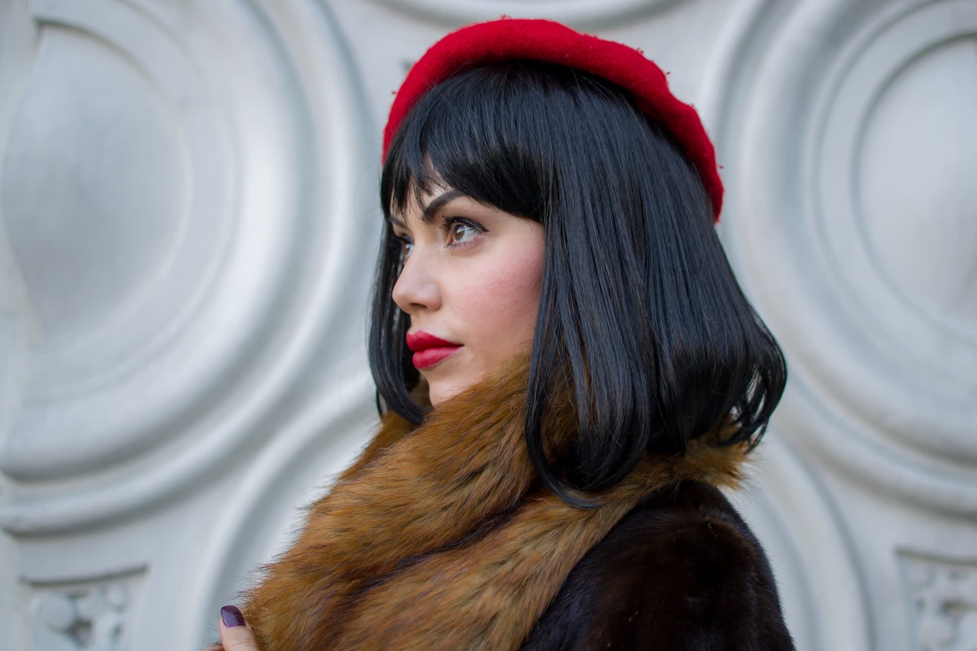 Woman wearing a vintage red beret with matching red lipstick