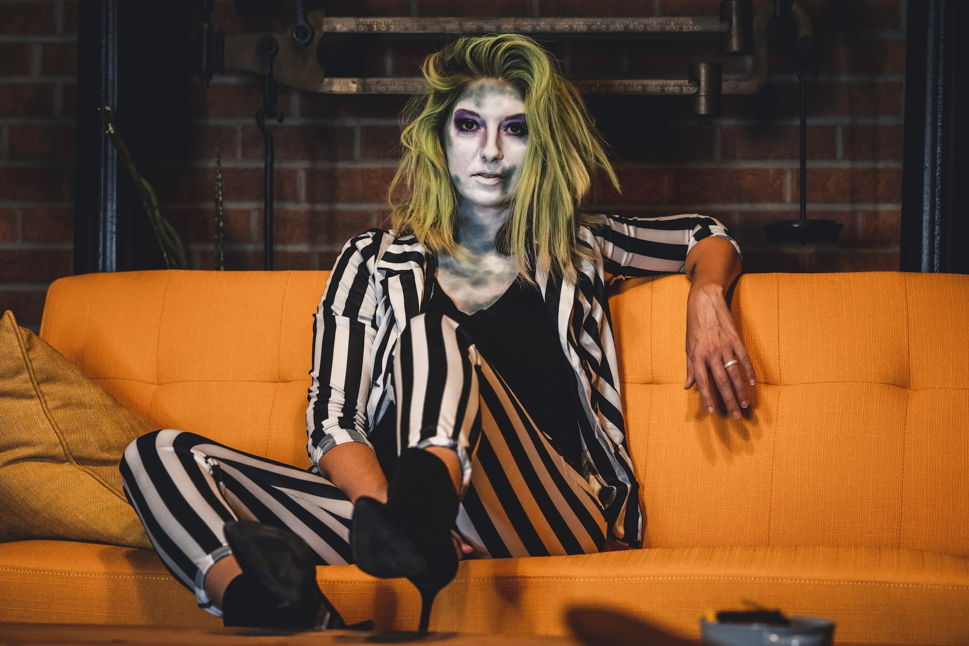 Woman wearing a black and white striped Halloween costume