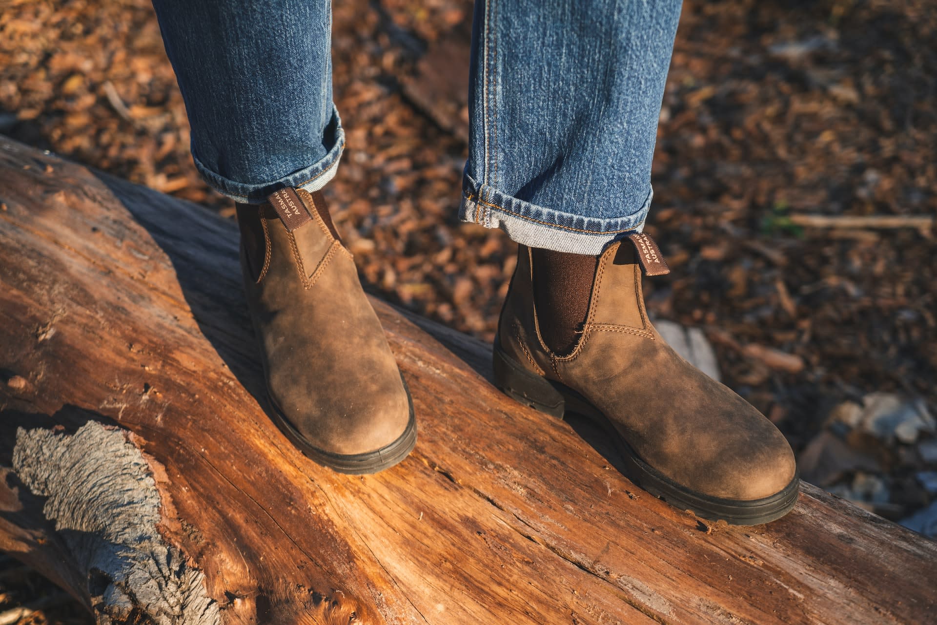 Woman wearing blue jeans with brown chelsea boots