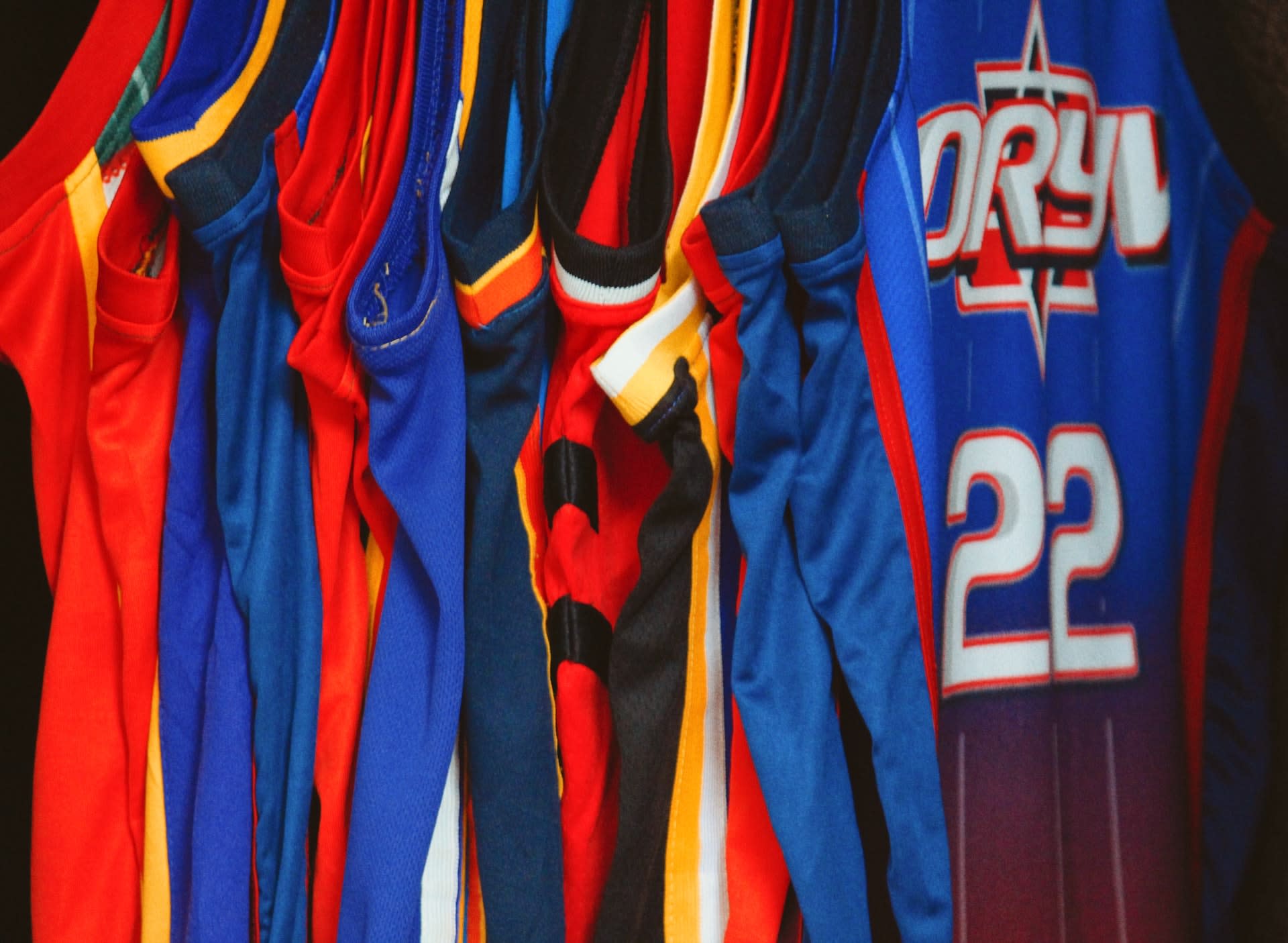 Selection of basketball jerseys on a clothing rail