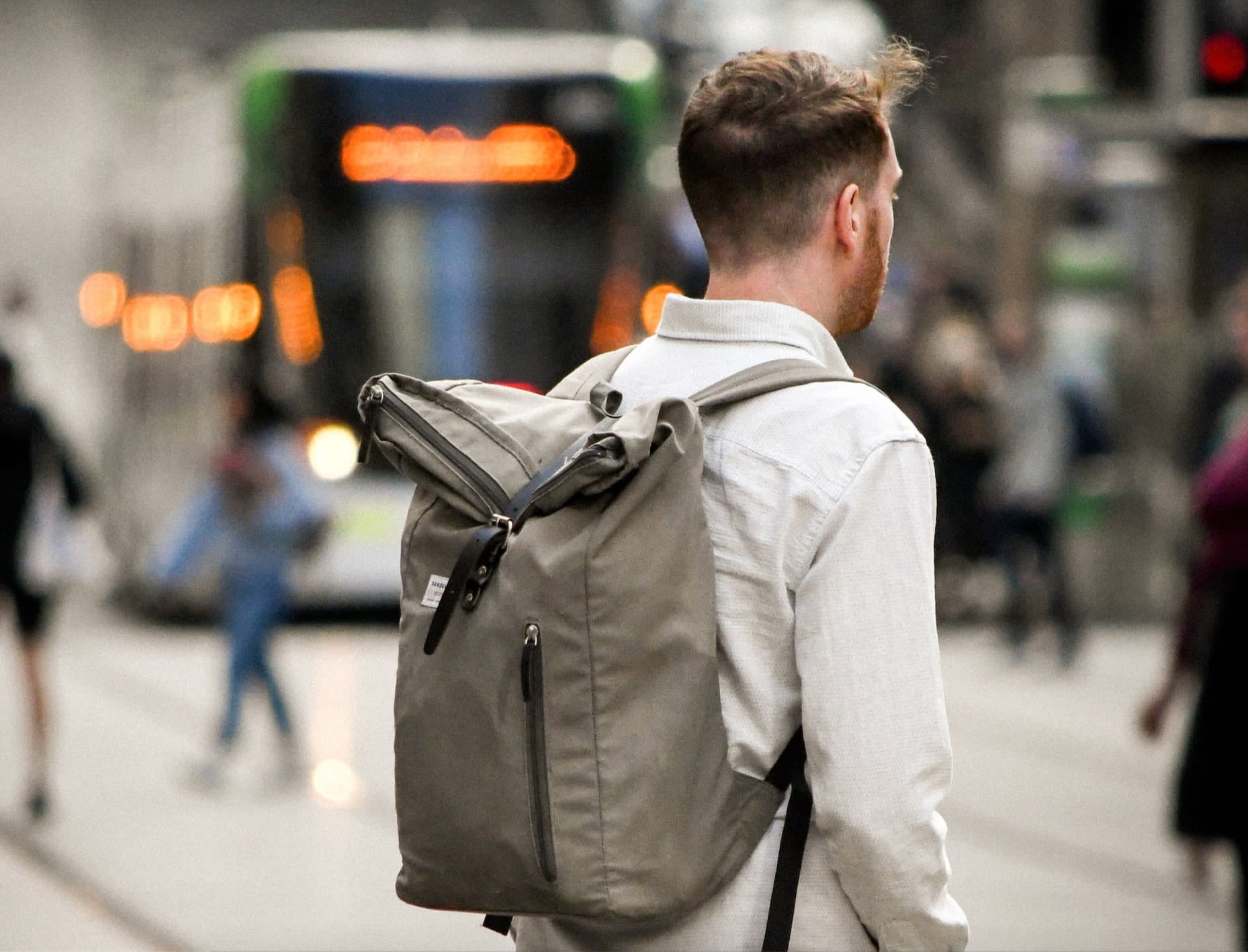 New dad wearing a second-hand grey nappy chnaging backpack