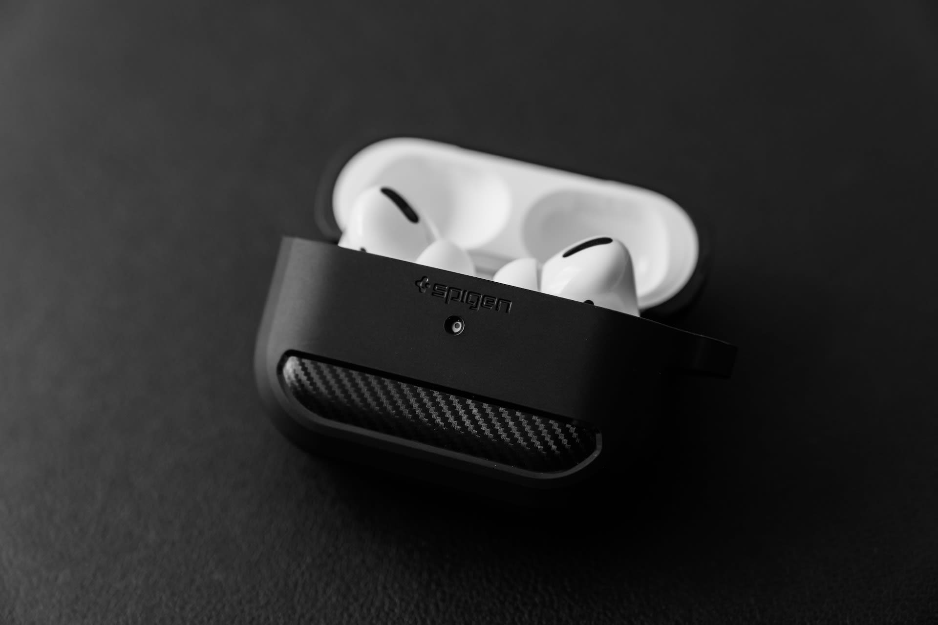 Airpods in a black protective case