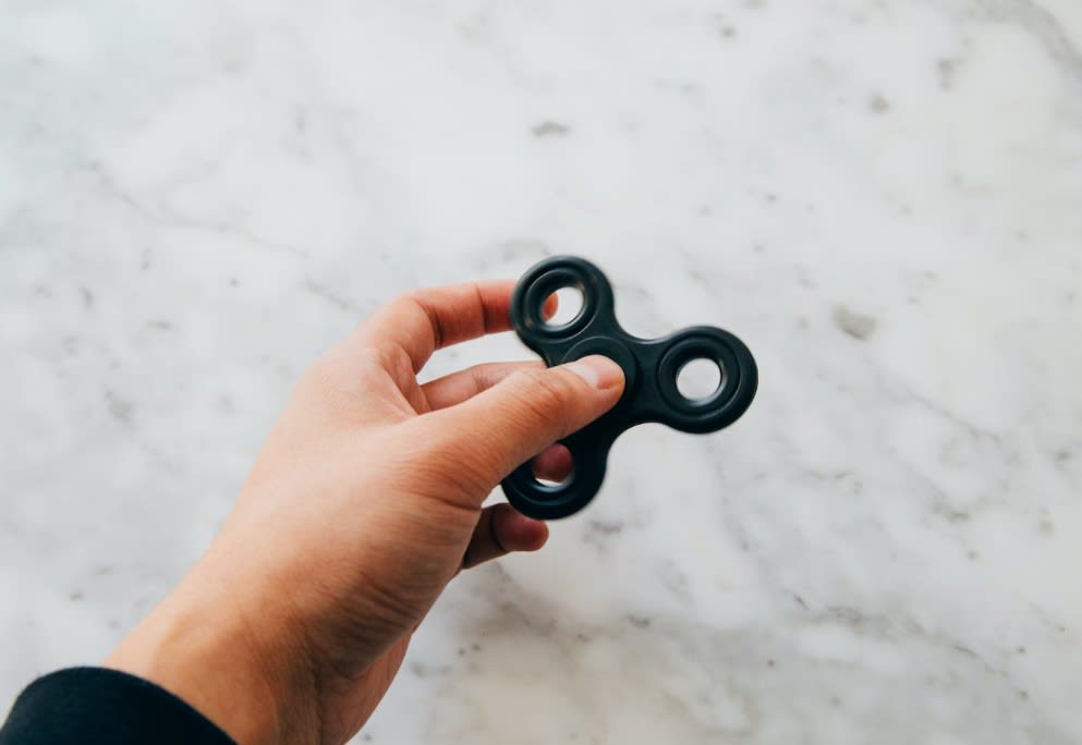 Man holding second-hand fidget spinner