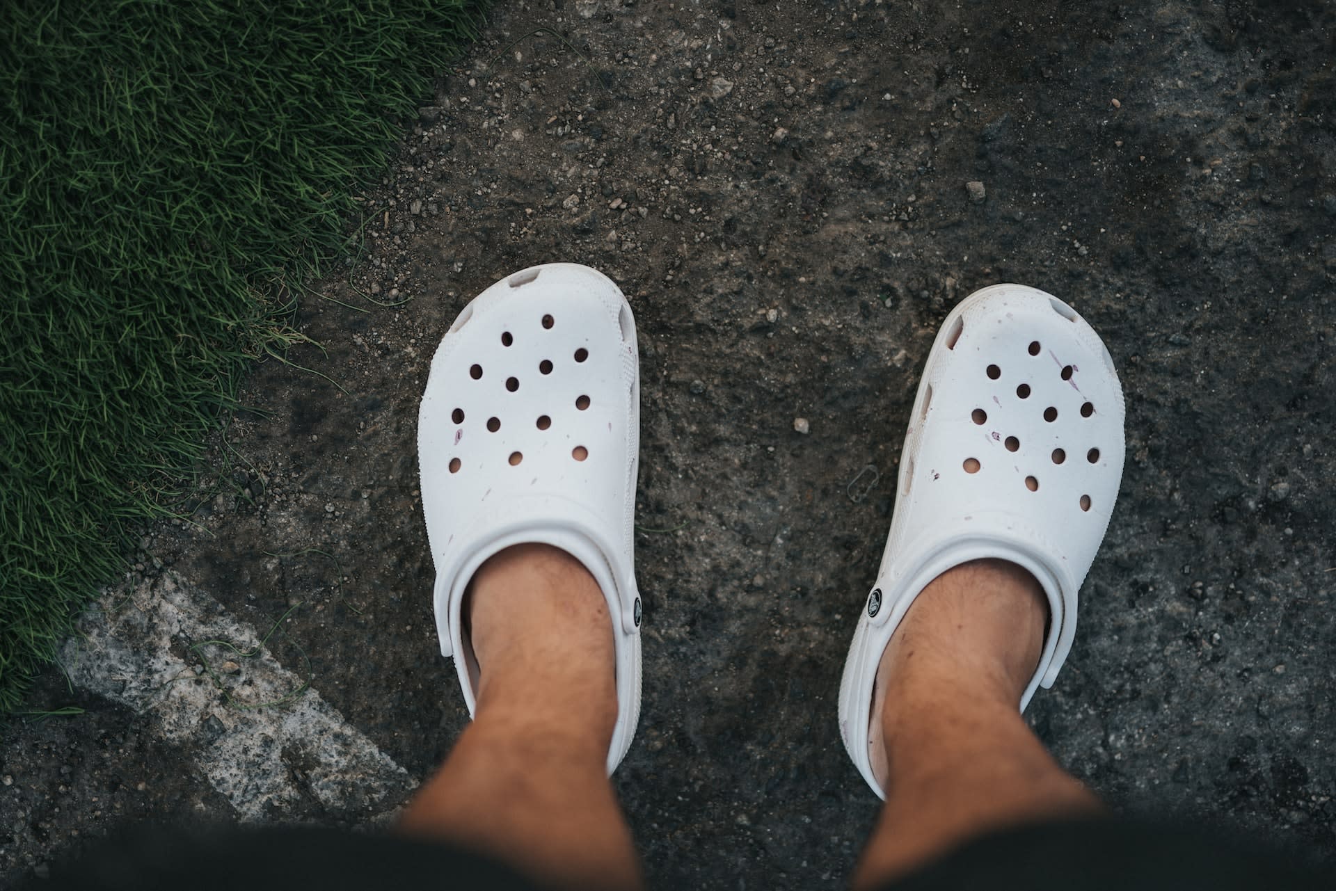 Person wearing white rubber crocs