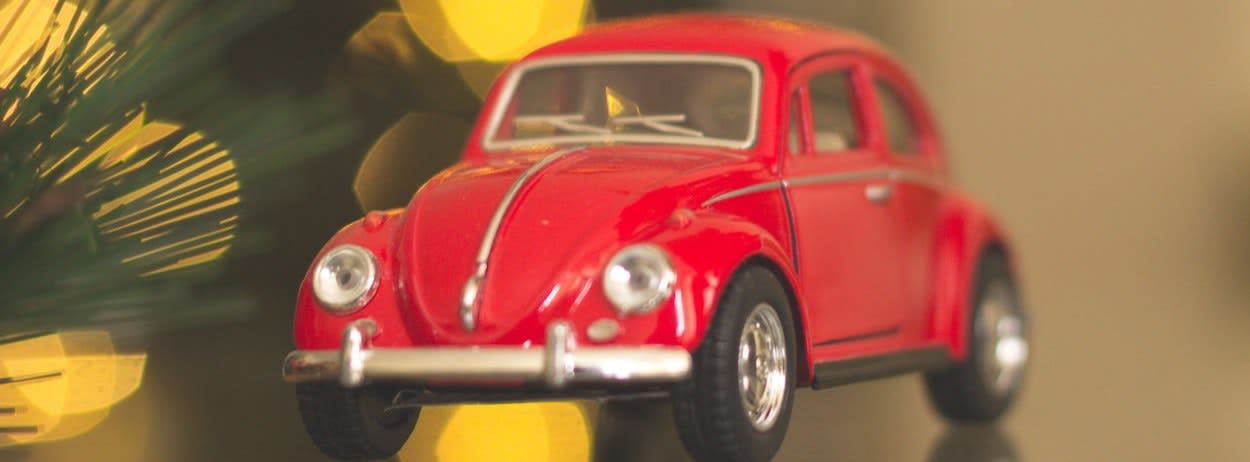 Close up of tiny red volkswagen car toy