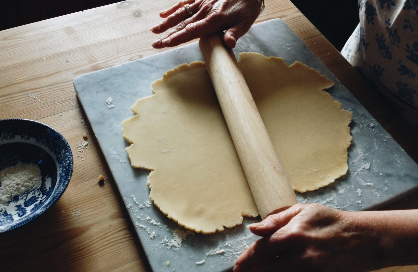 Person holding wooden rolling pin