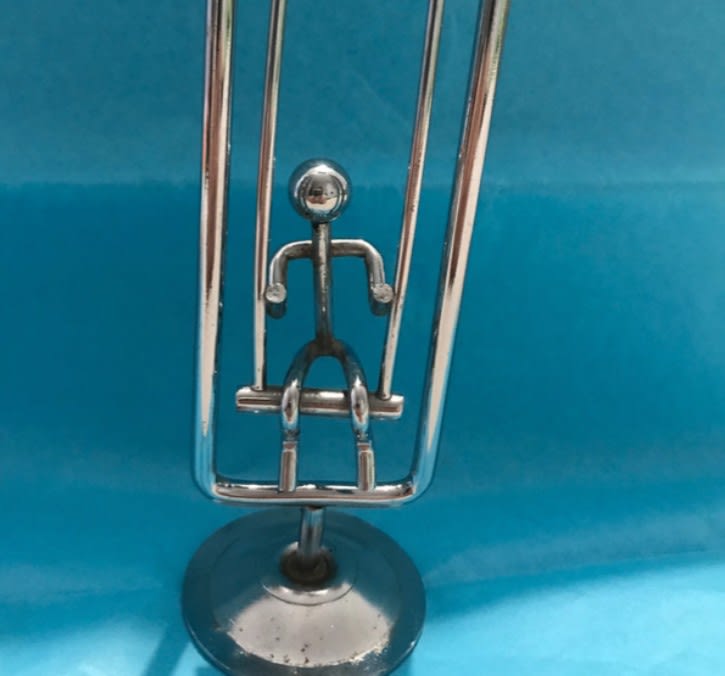 Vintage desk toy stick man on swing pendulum