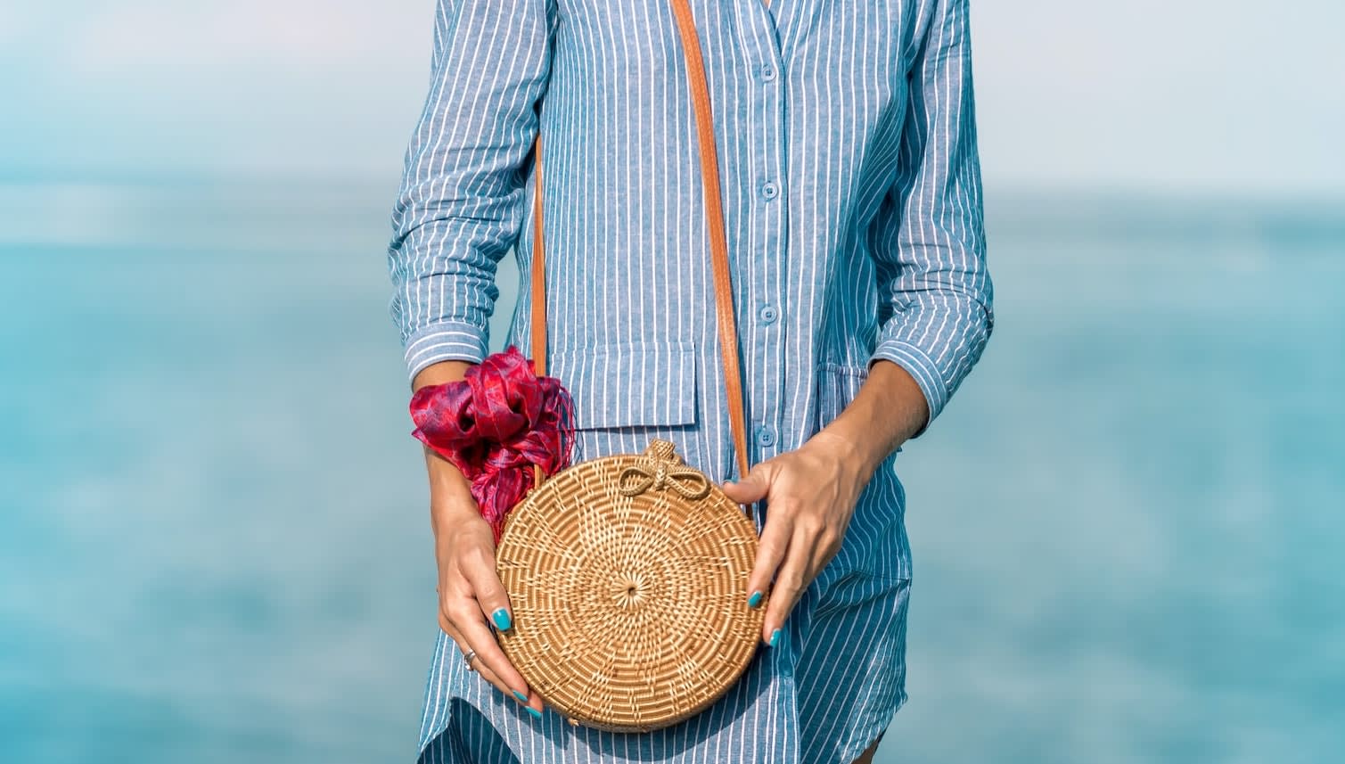 Close up of woman holding on to her cross body bag