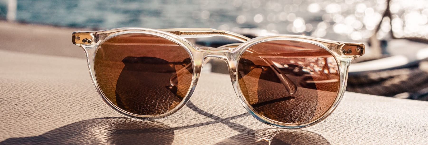 sunglasses on a wall beside the sea