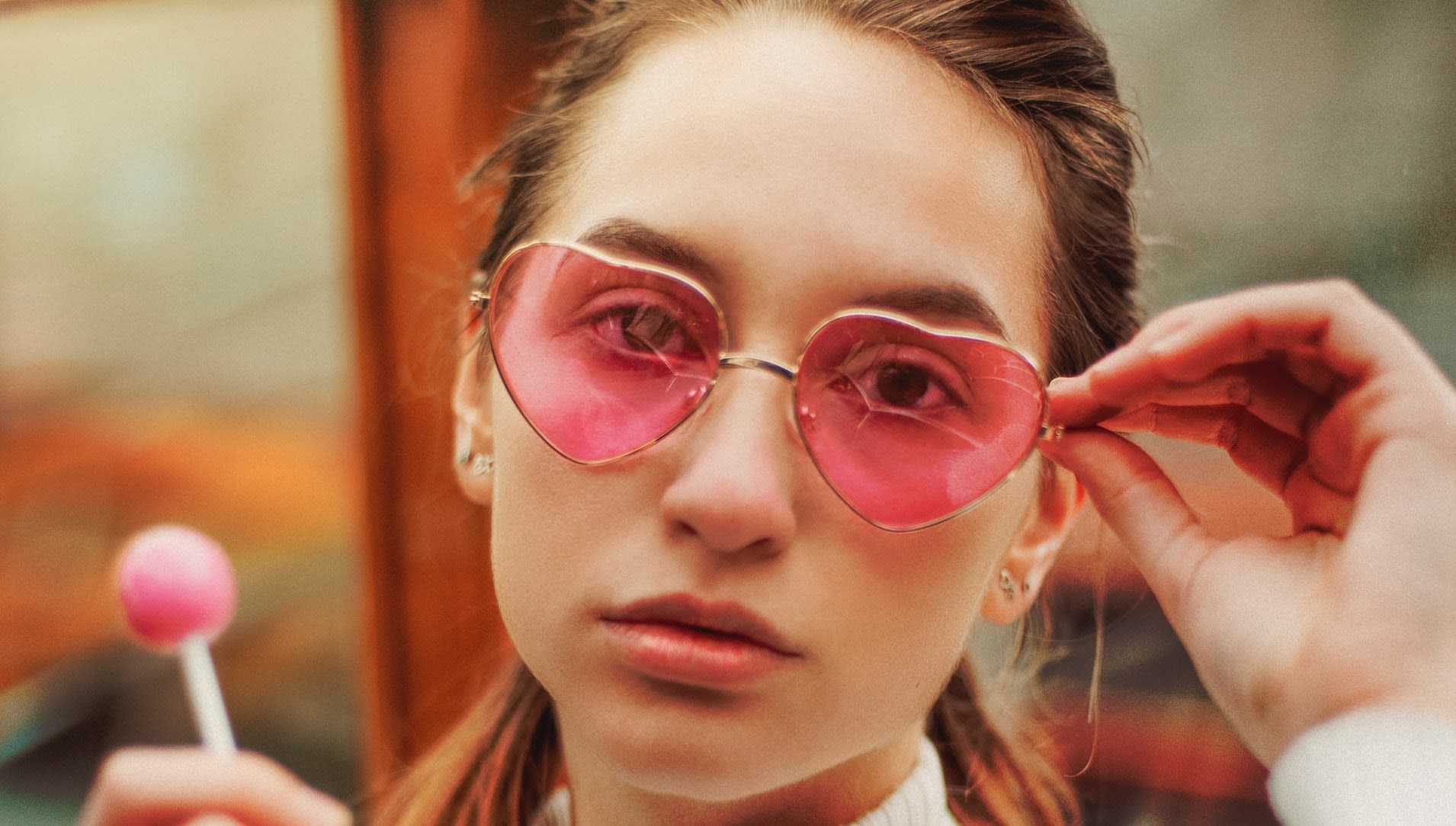 Woman wearing heart shaped sunglasses