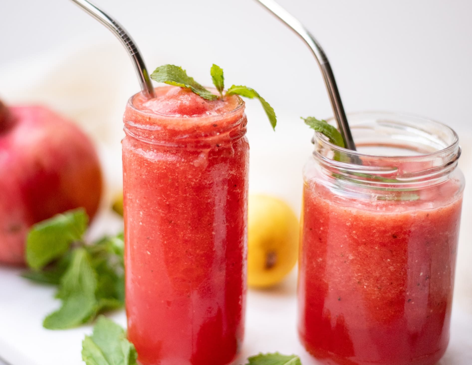 Two glasses filled with red slushies