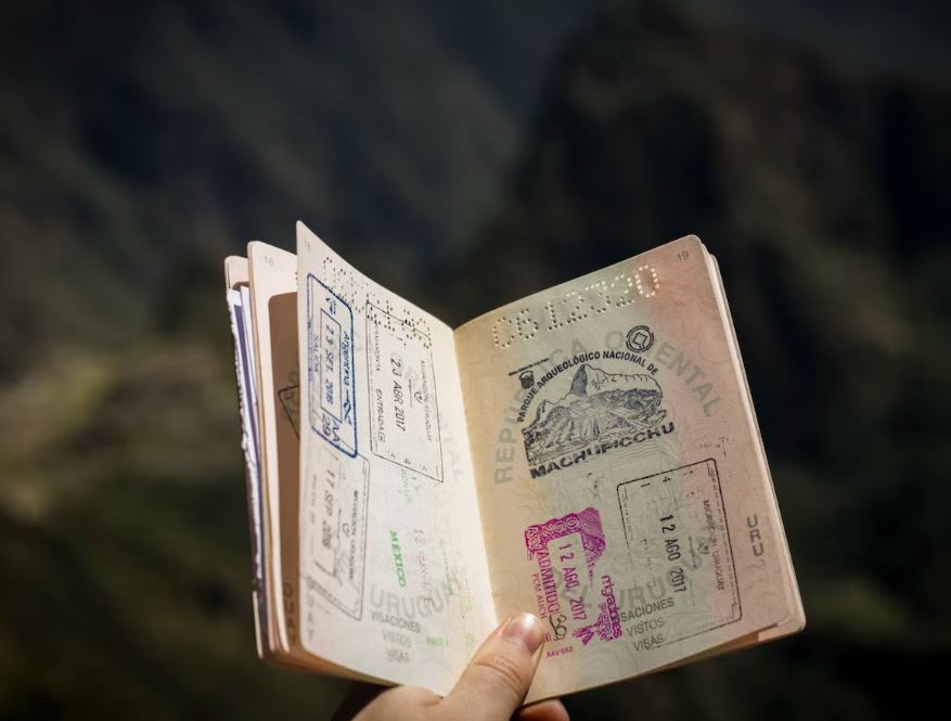 Passport pages open full of stamps including Machu Picchu