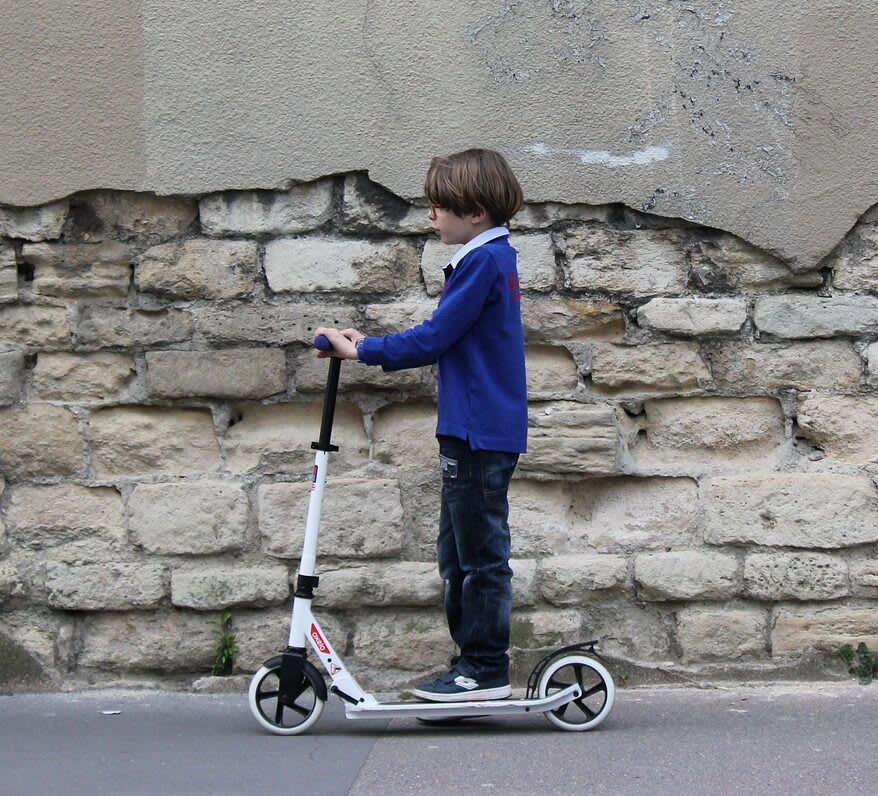 Boy on 2 wheel scooter