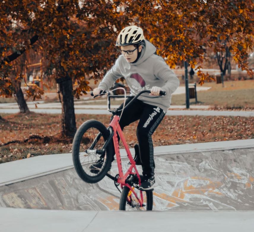 Kid riding BMX bike in skate park