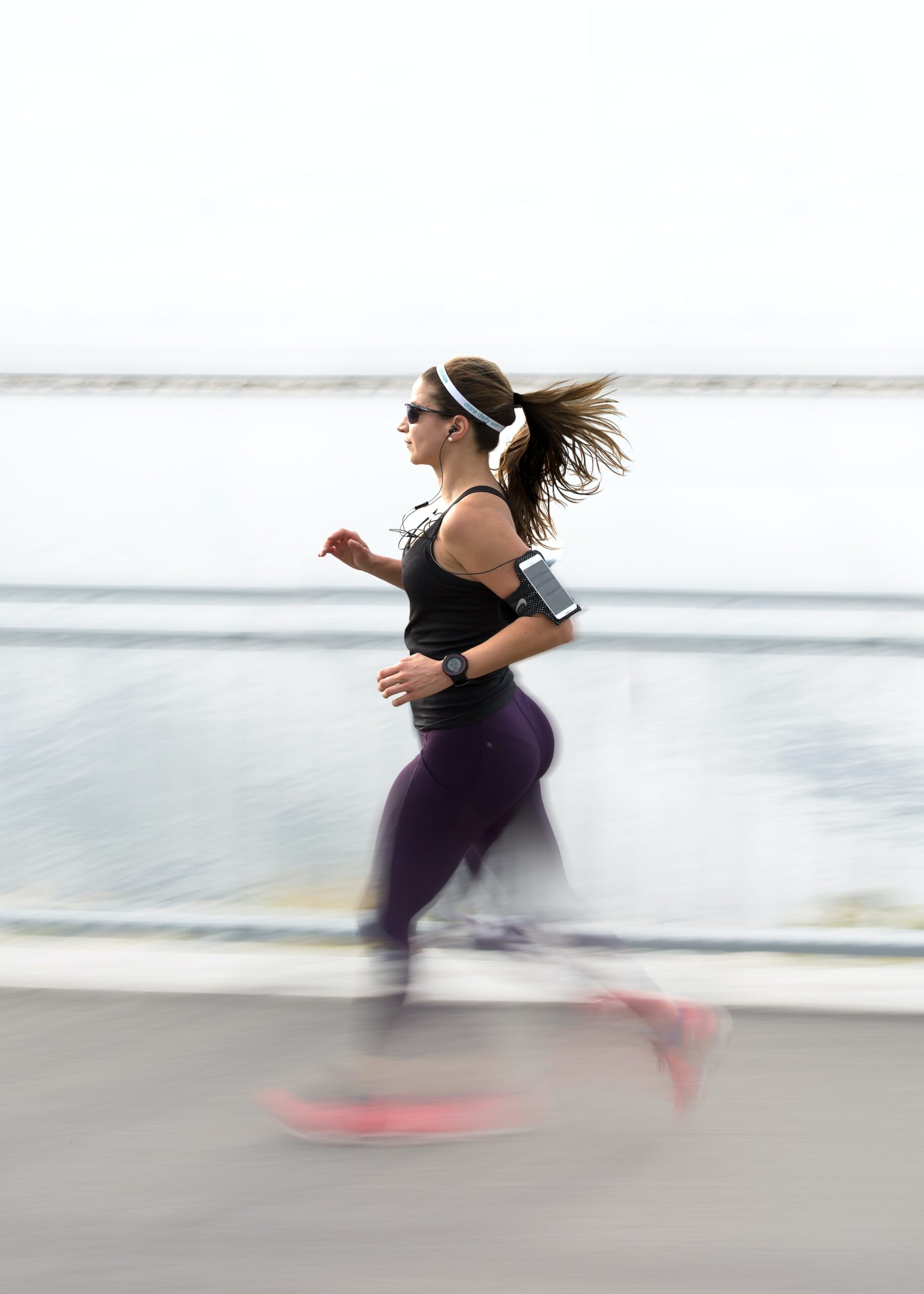 Woman running wearing a preloved phone armband