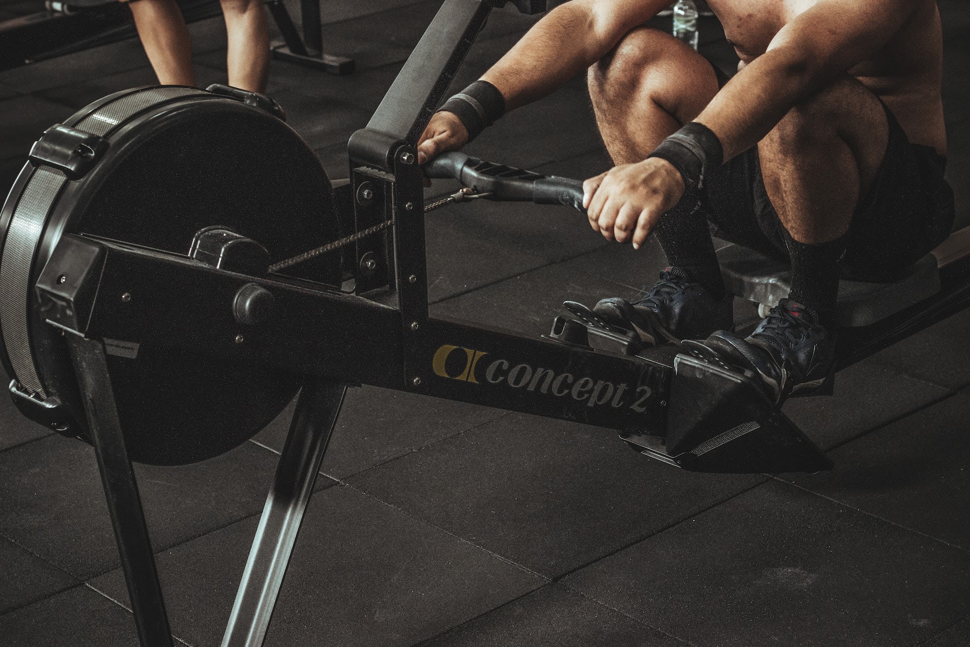 Person using a rowing machine in a gym