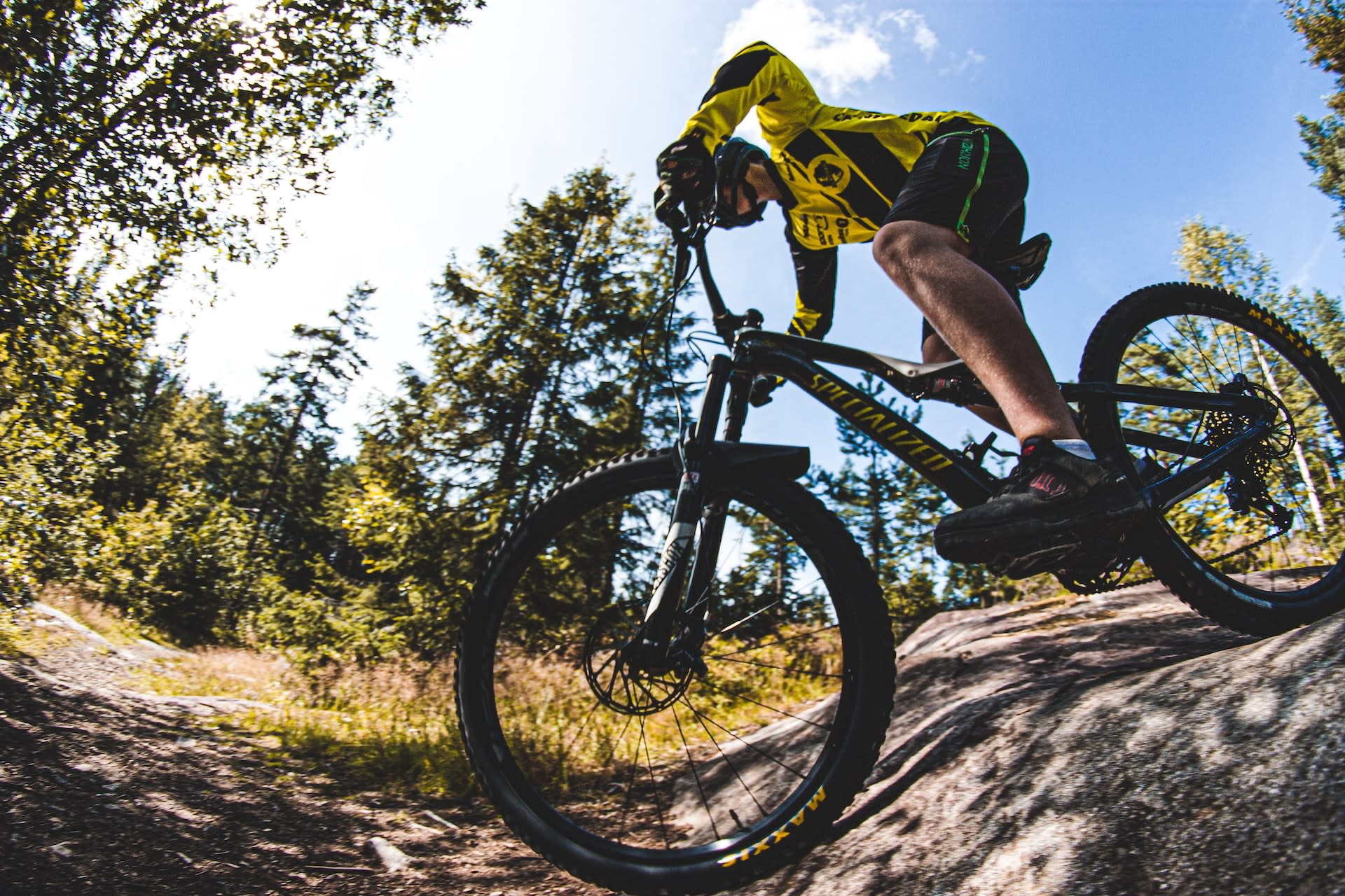 Man rising mountain bike on a mountain