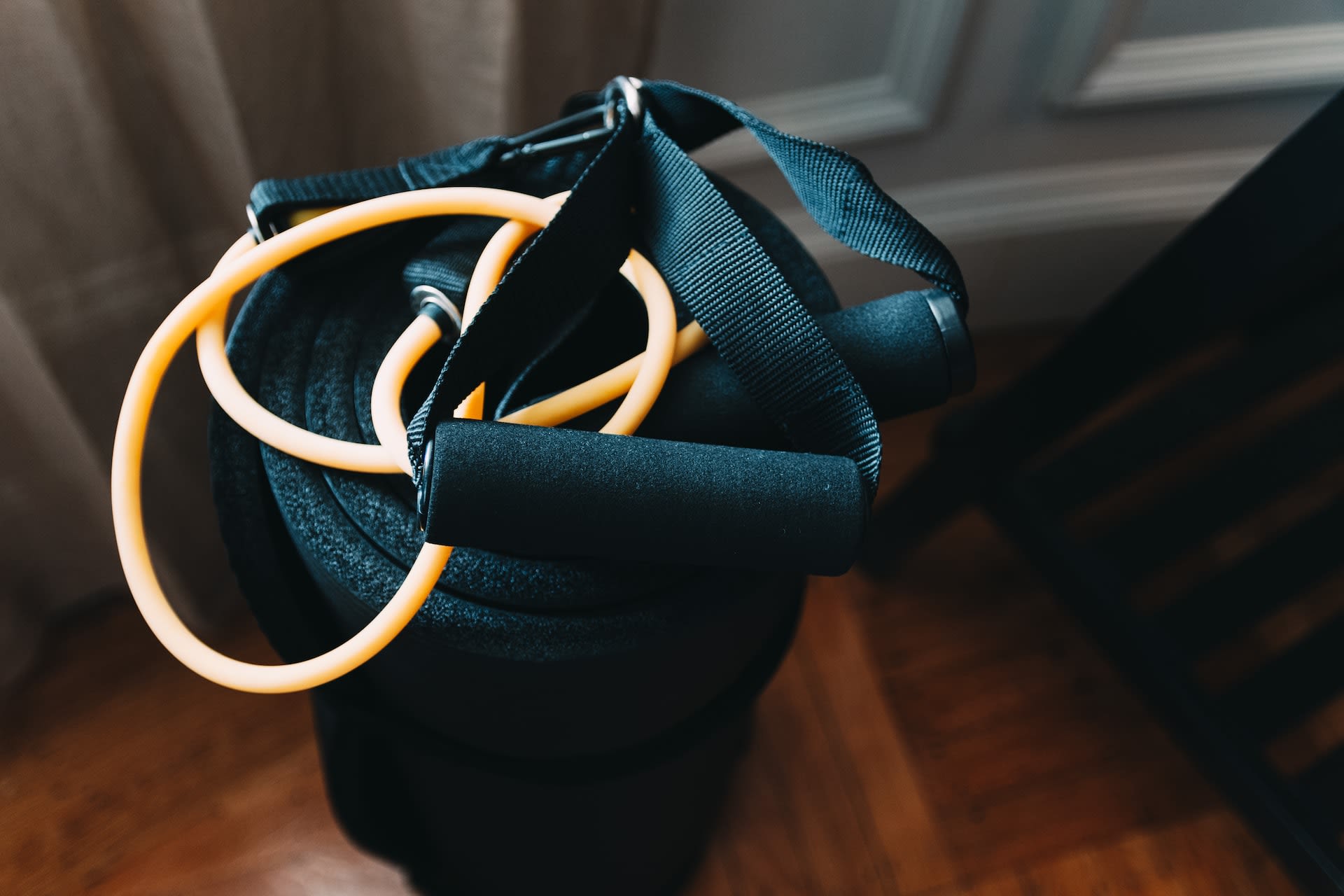 Second hand skipping rope on top of exercise mat