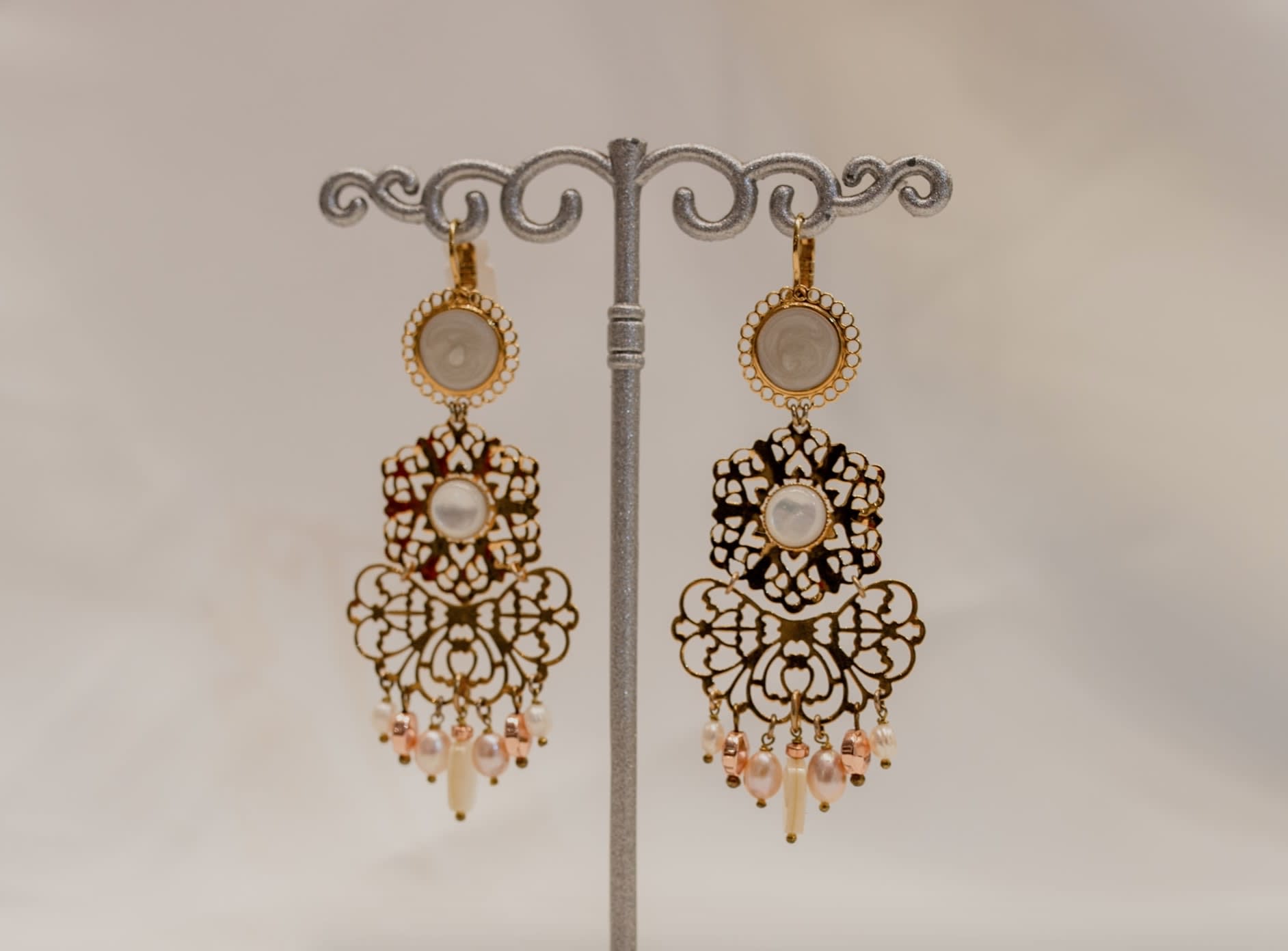 Vintage chandelier earrings on a display stand