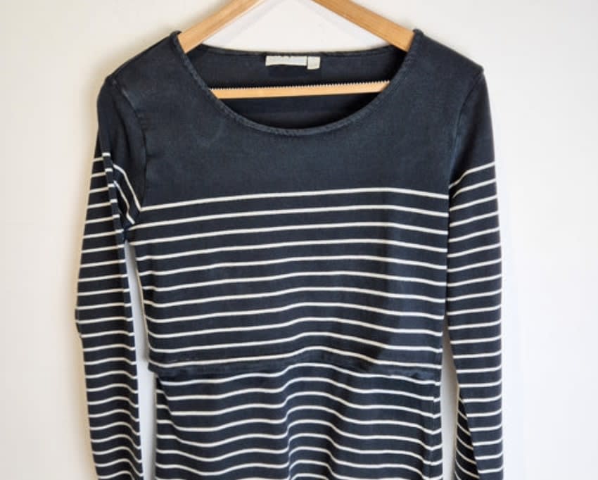 Pre-loved navy Breton top on a clothing hanger