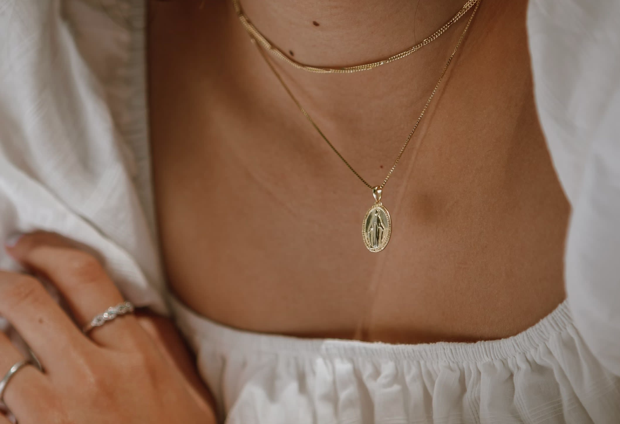 Woman wearing dainty gold jewellery