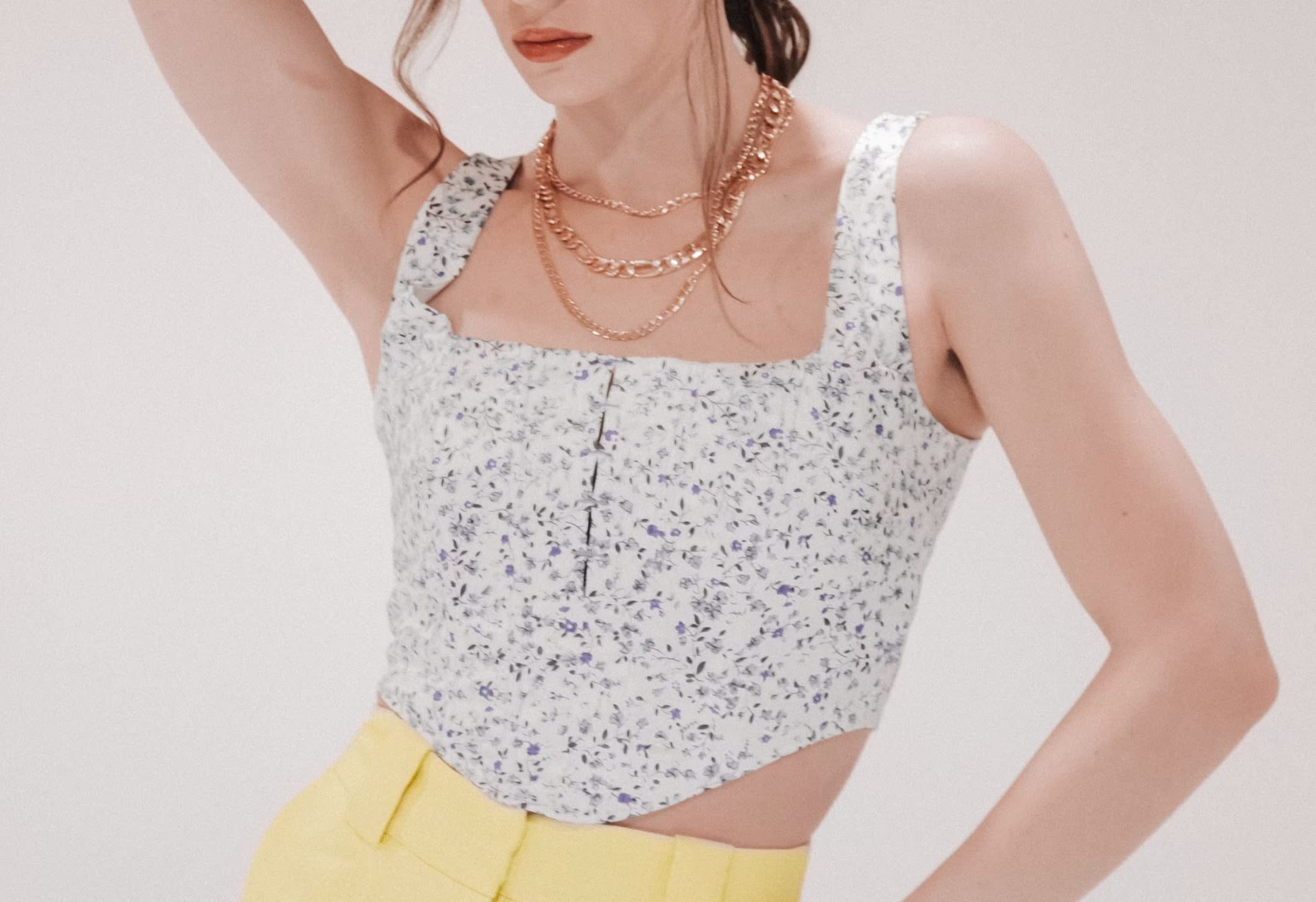 Womanwearing a second-hand light blue floral corset top