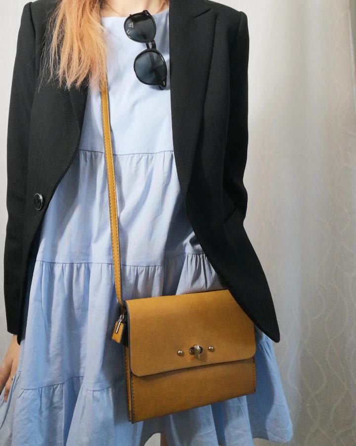Jen from Pegz Preloved wearing a denim dress, sachet bag and black blazer and sunglasses, all second-hand