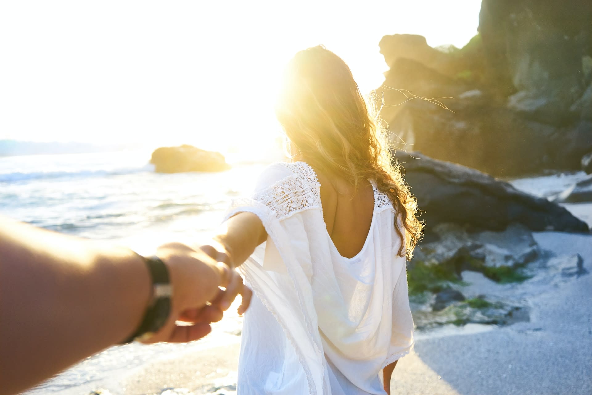 Woman wearing a second-hand white flow beach cover up