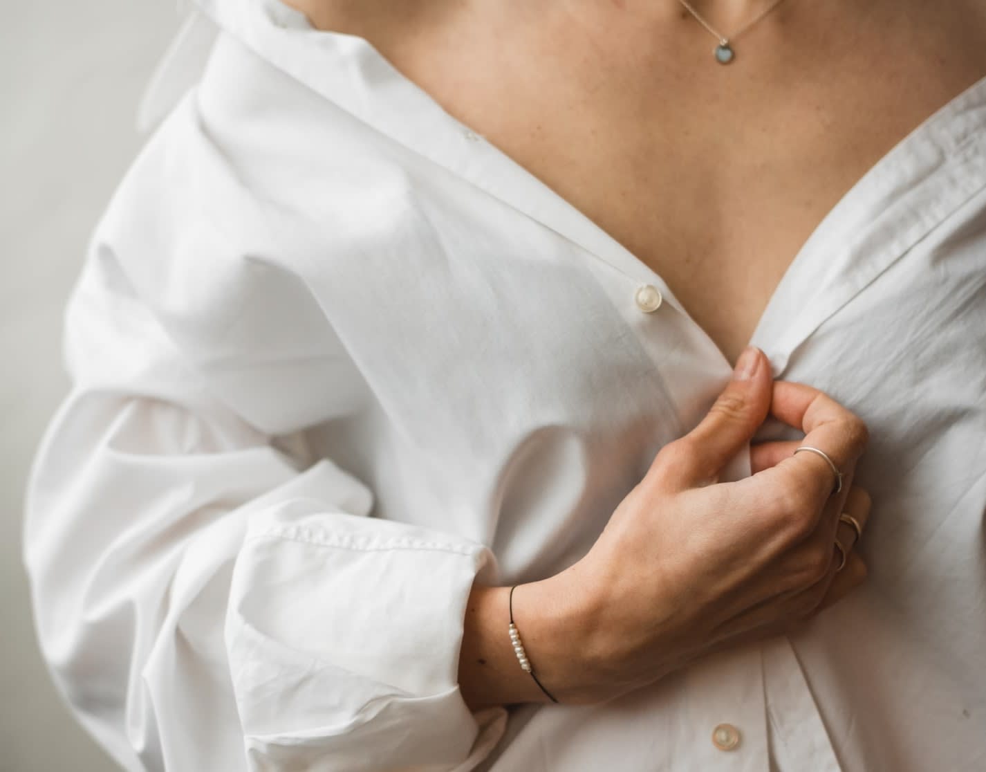 Woman wearing a pre-loved white linen shirt