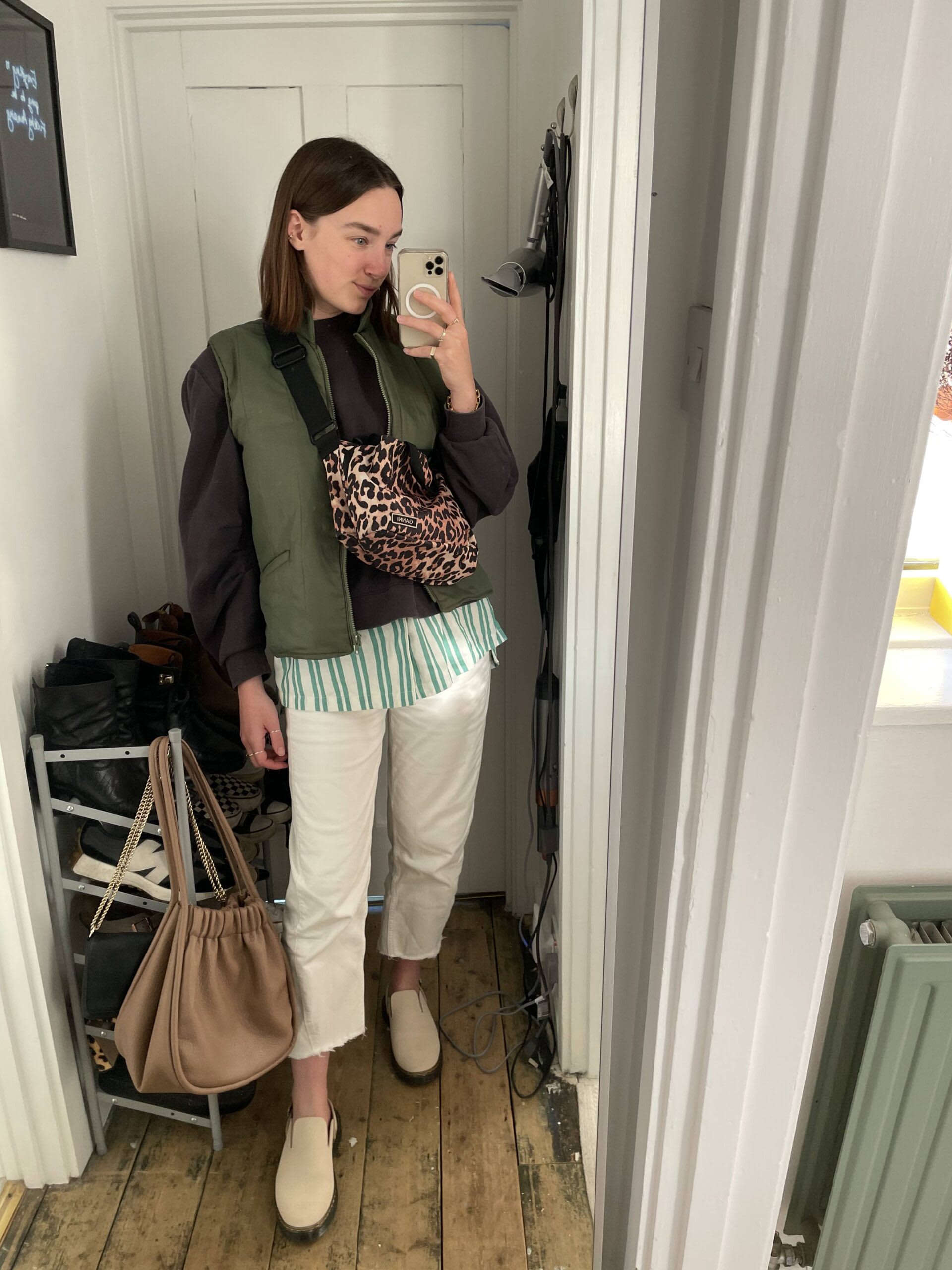 Iso Neville - layers of intrigue - wearing second hand leopard print crossbody bag, dark grey jumper, green gilet, wide leg jeans and beige mules