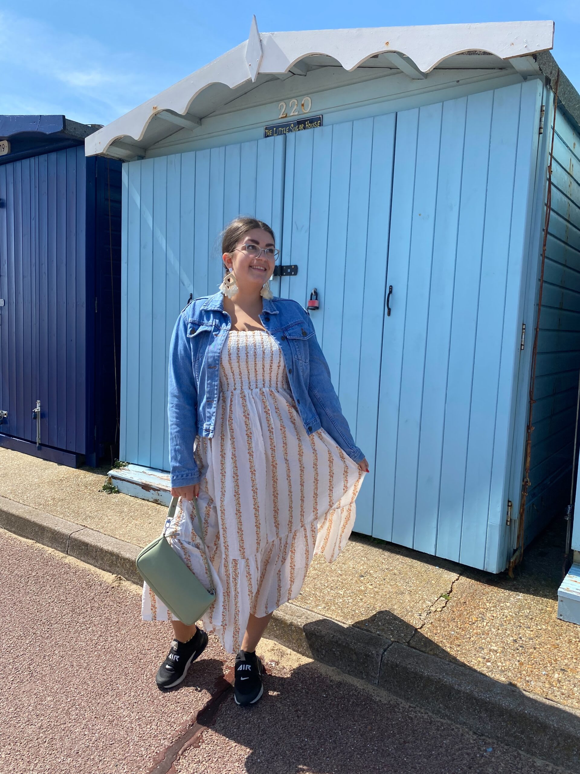 Amy Lorenz in a sun dress plus denim jacket at the seaside
