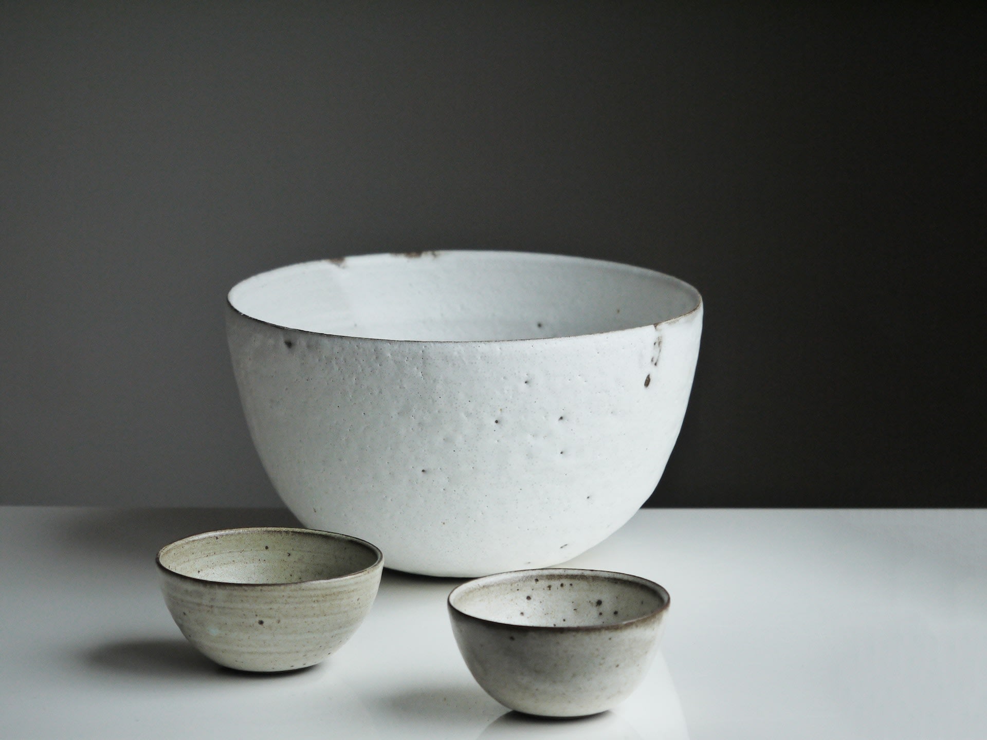 three natural ceramic bowls