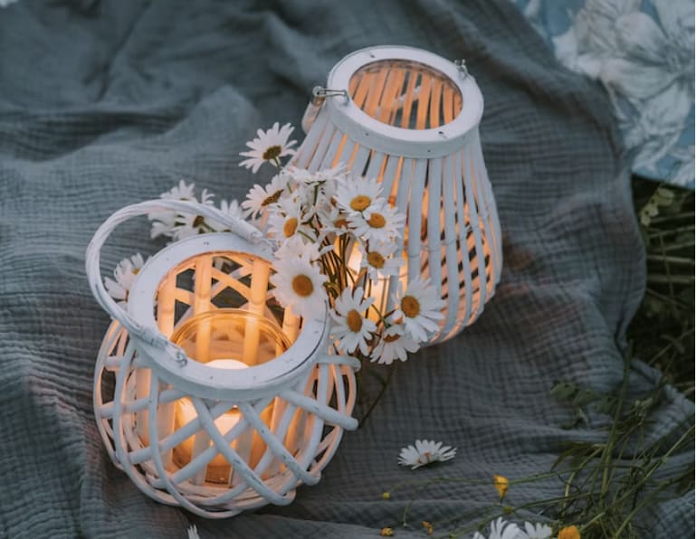 two outdoor lamps on a picnic blanket