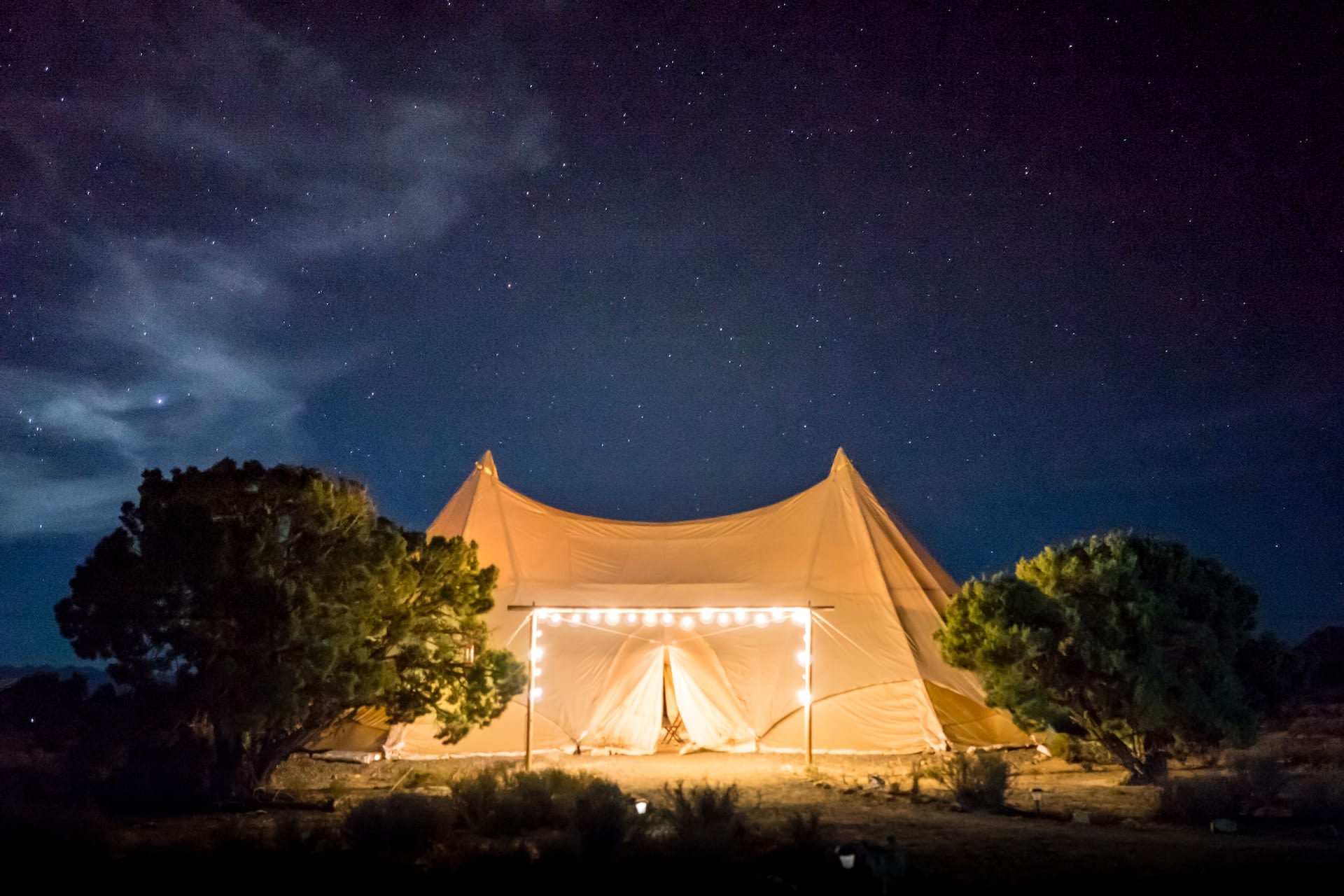 outdoor white gazebo tent lit up in the night