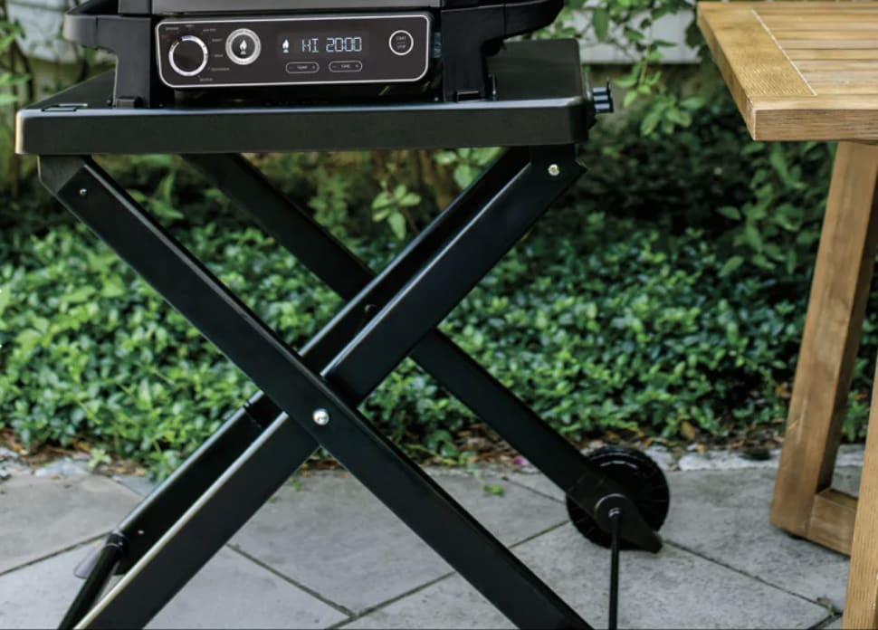 a BBQ standing on a patio