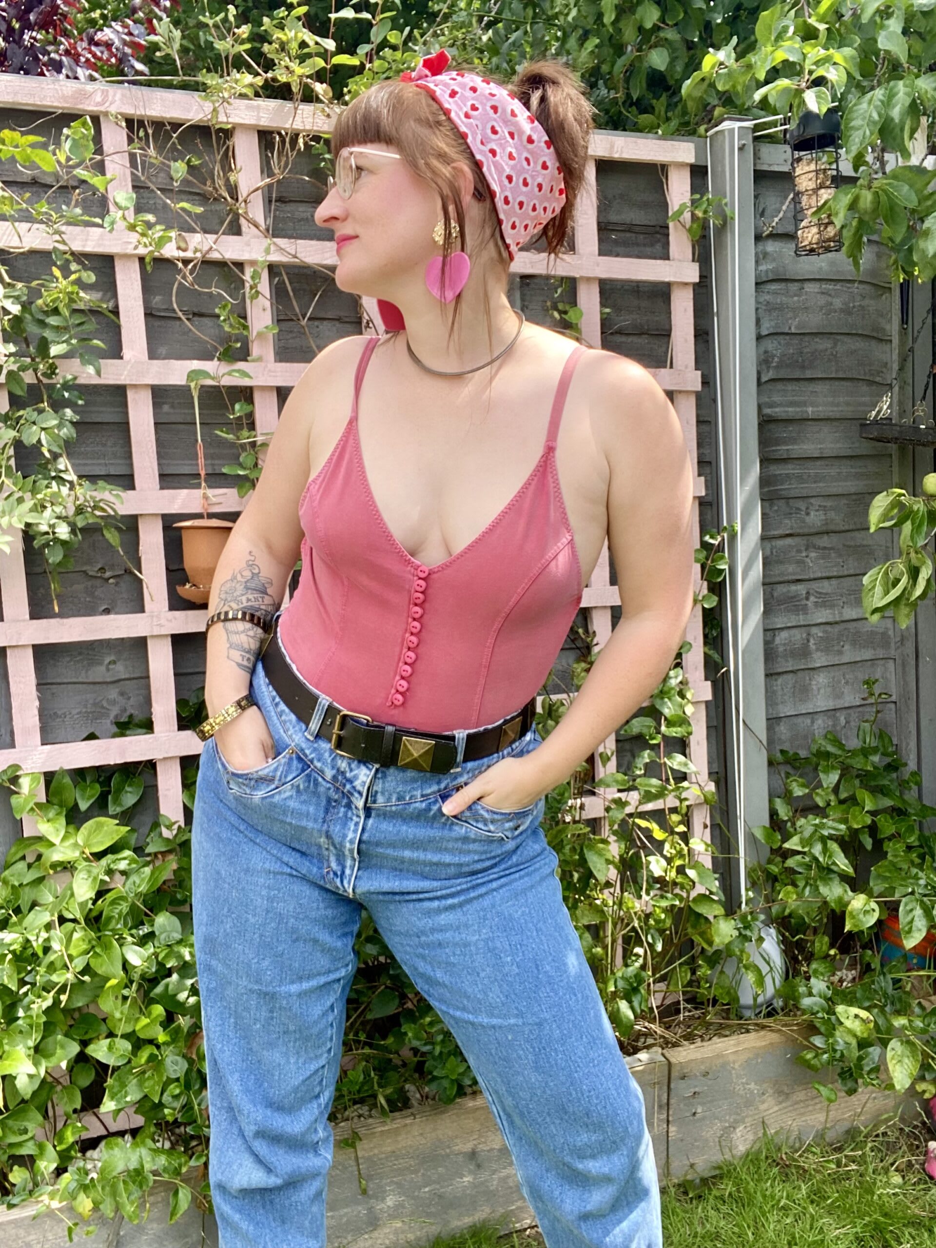 Used and Loved Curator Ali wearing a vintage swimsuit with jeans and a pink headscarf.