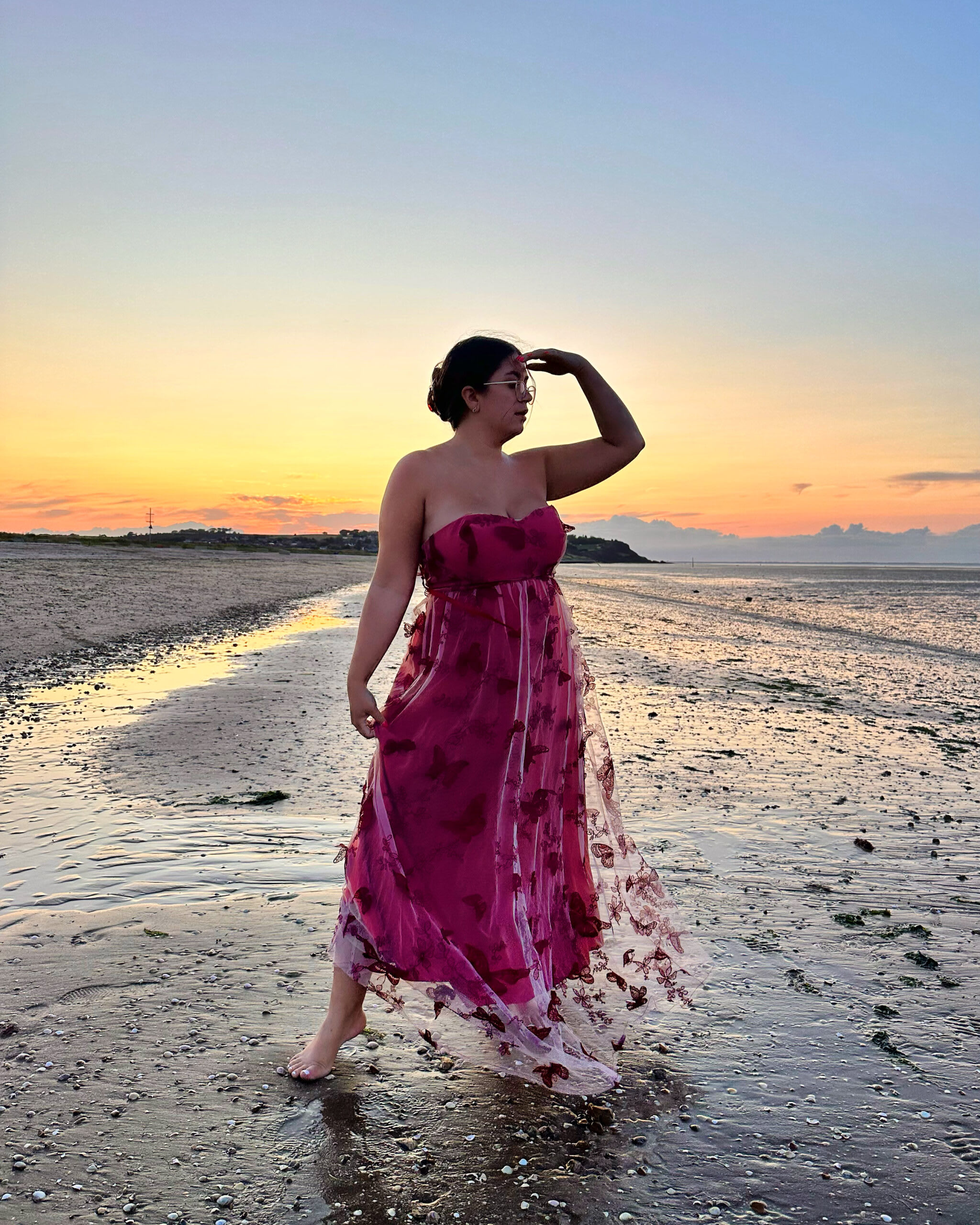 Amy styling a pre-loved evening dress for a sunset beach walk.