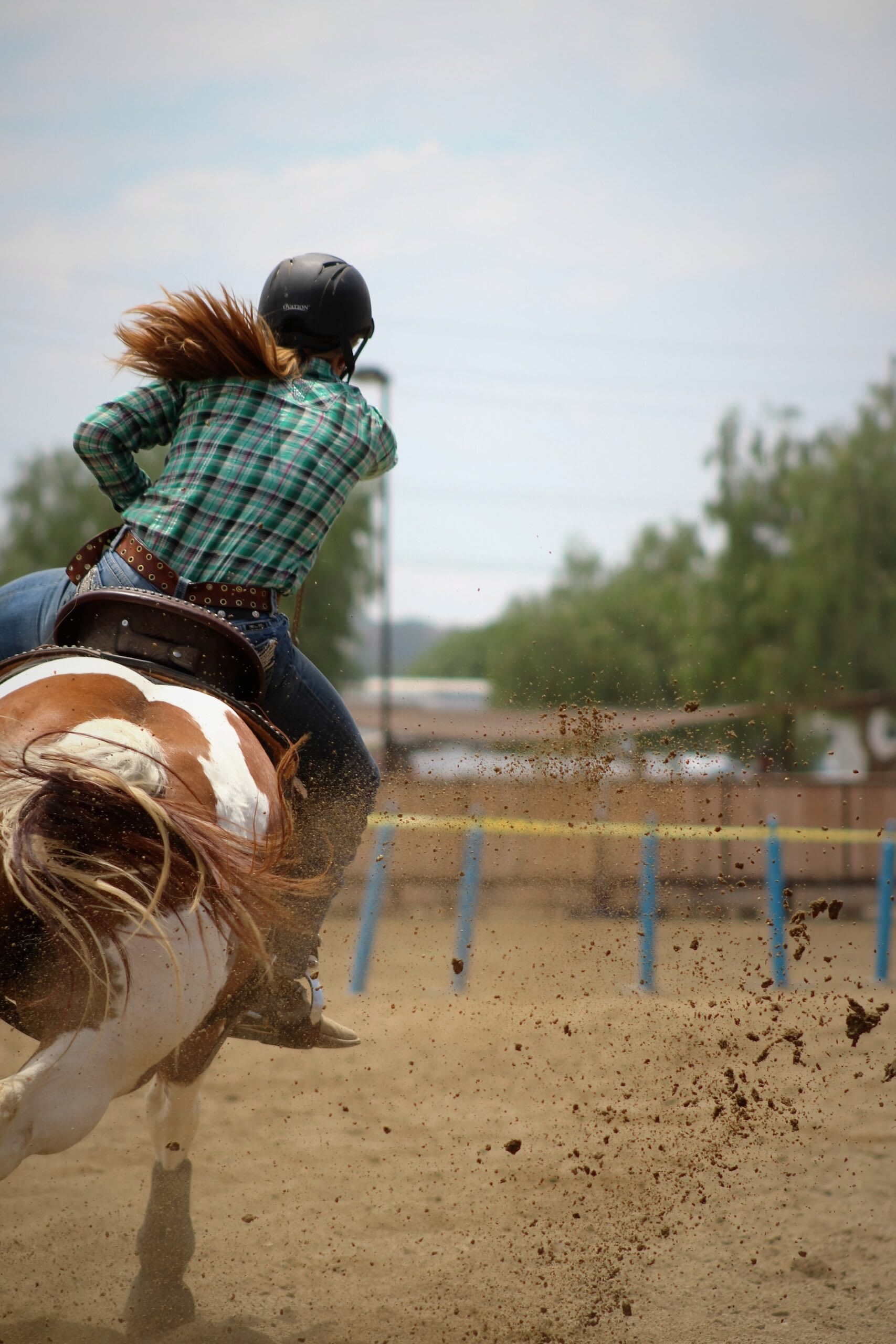 Woman racing on a skewbald horse