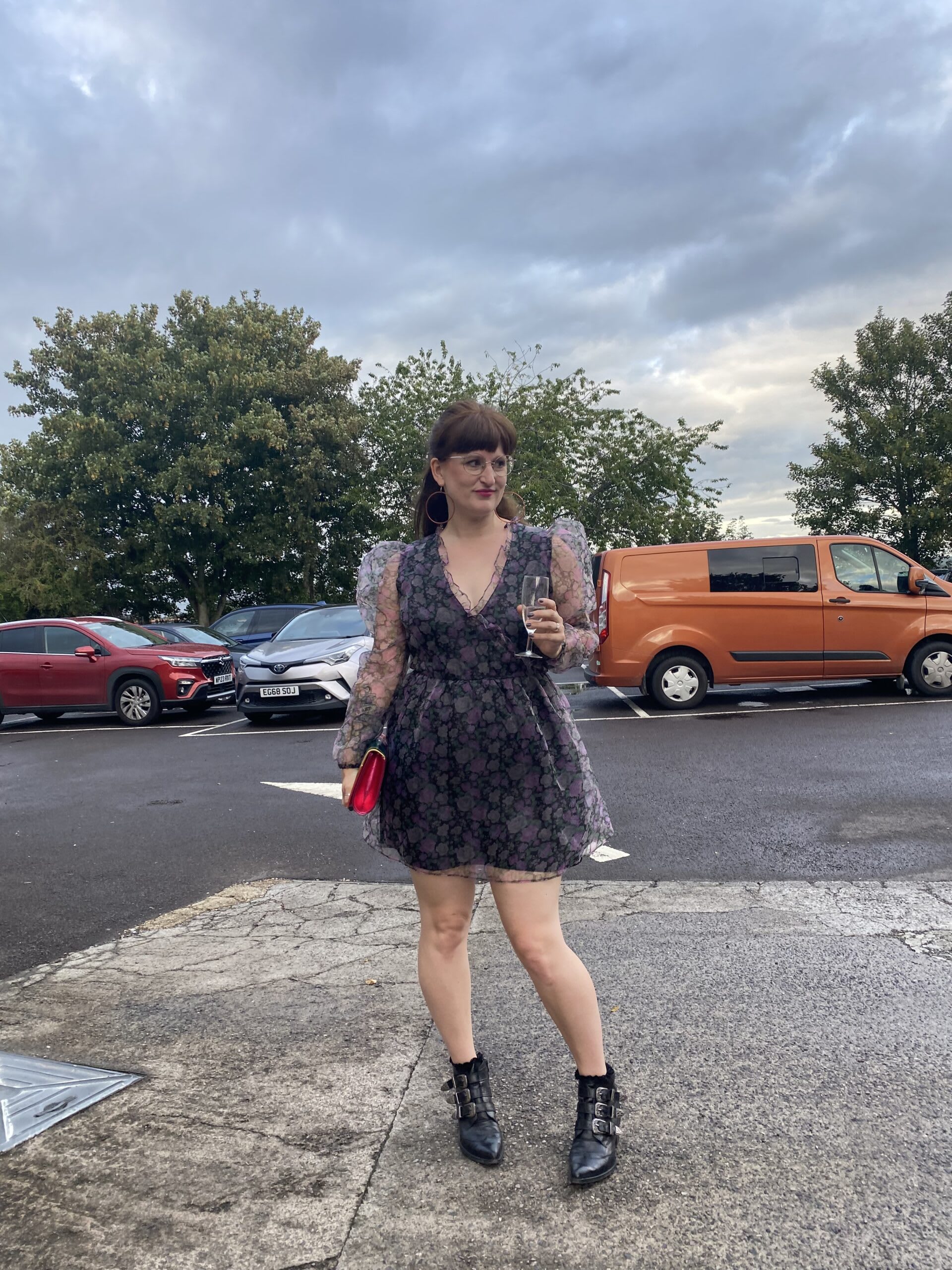 Little Splash styling a little black dress with boots and clutch bag for a wedding reception.