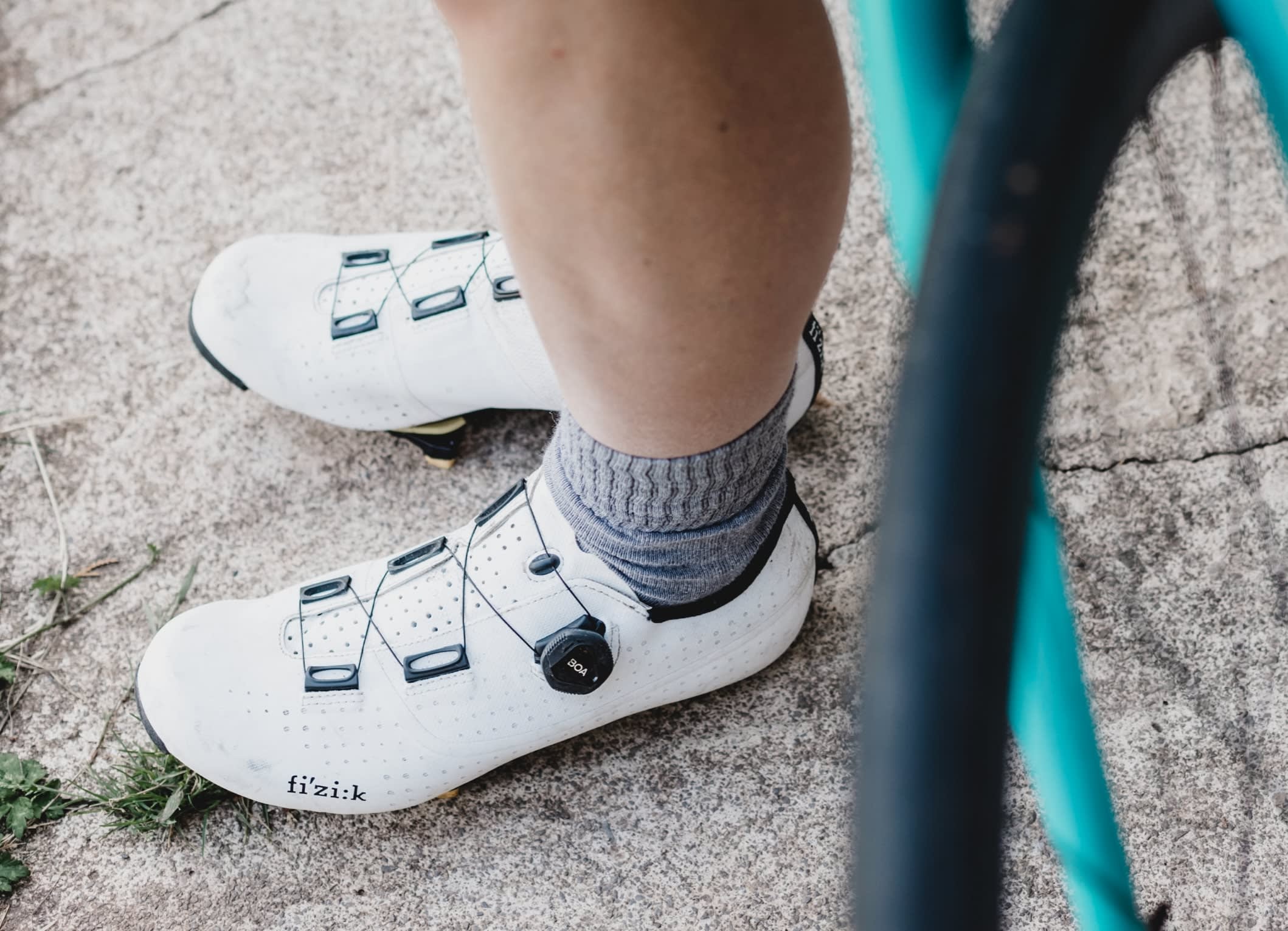 Man wearing white cycling clip shoes.