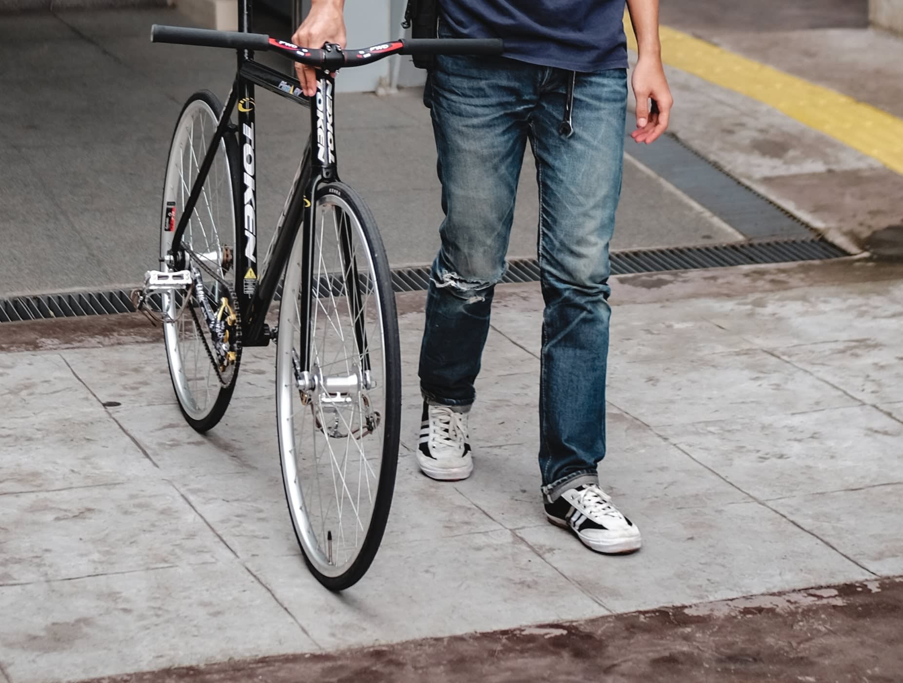 Commuter wearing a pair of pre-loved flat cycling trainers.