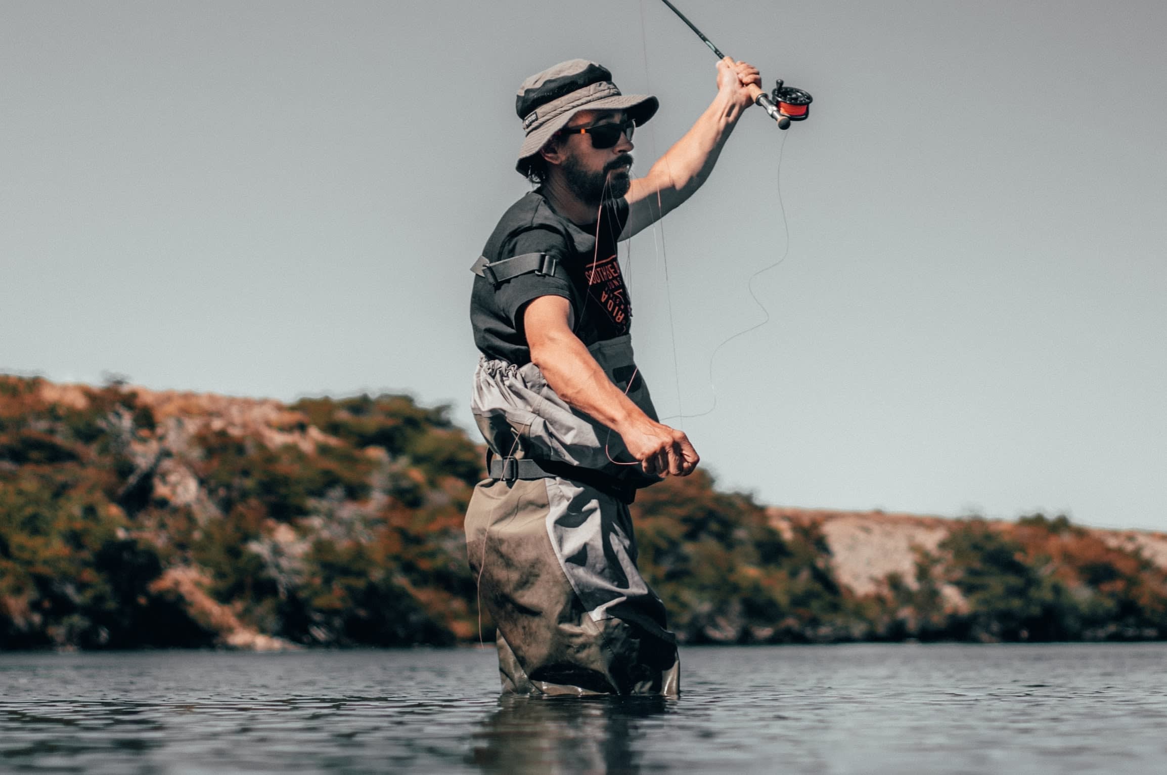 Man fishing wearing second hand waders.