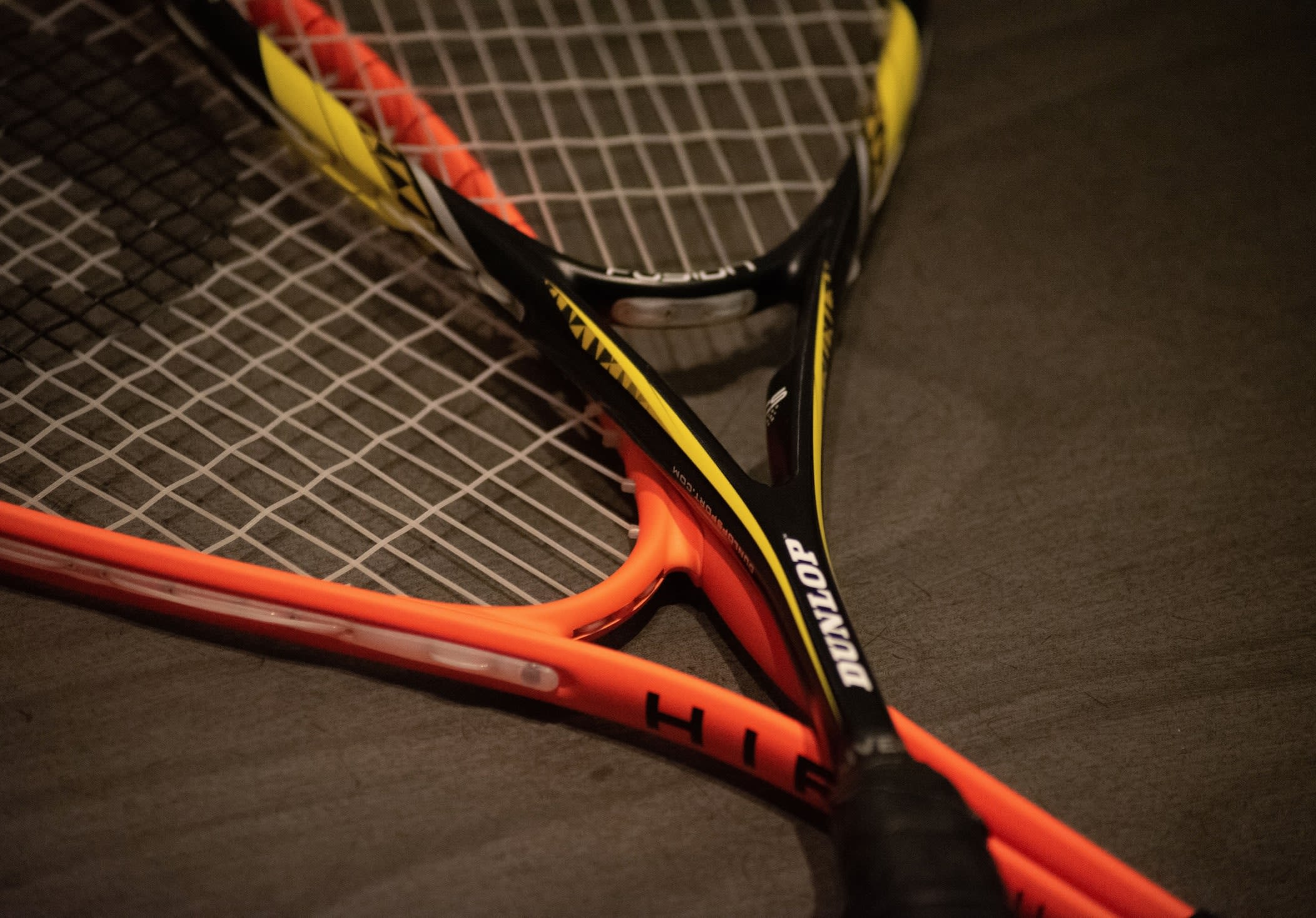 Yellow and black pre-loved Dunlop racket.