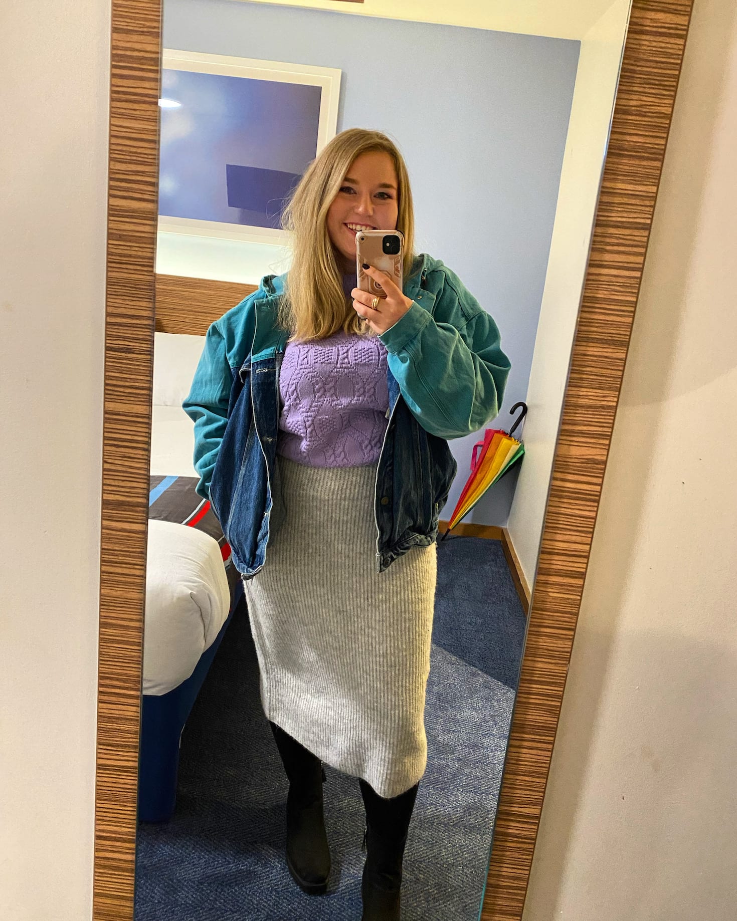 The thrifty edit poses infront of a mirror while wearing a cosy night pub look