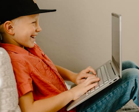 Kid playing on a second-hand laptop